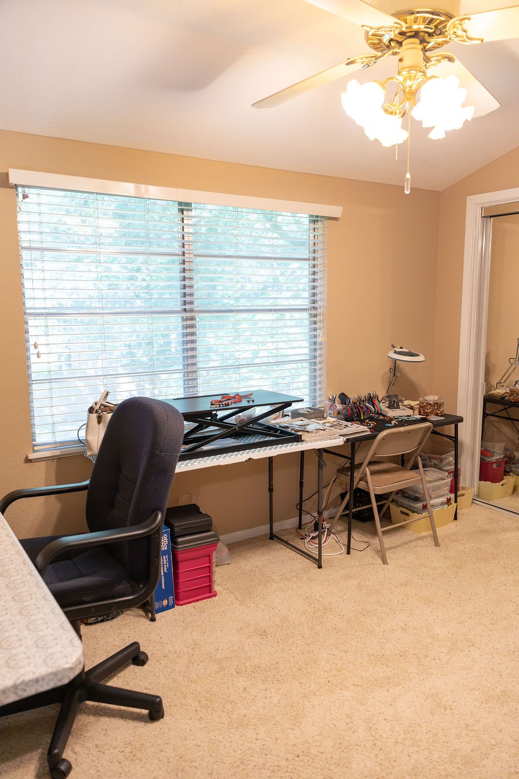 Currently used as a craft room, this versatile space also makes a wonderful bedroom. Large windows overlook the beautiful backyard, creating a peaceful setting filled with natural light.