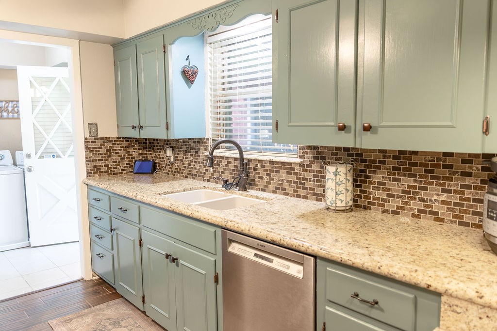 Beautiful custom-built cabinetry, painted in a rich, modern blue, creates a stunning focal point in the kitchen. Paired with elegant granite countertops, this space offers the perfect blend of timeless style, abundant storage, and everyday functionality.