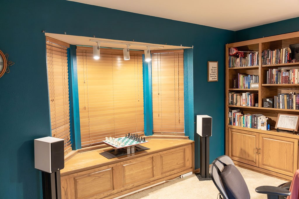 A beautiful bay window overlooks the stunning mature trees in the front yard, filling the room with natural light and offering peaceful views. The charming window seat includes built-in storage, creating the perfect spot to relax with a good book while adding both character and functionality.
