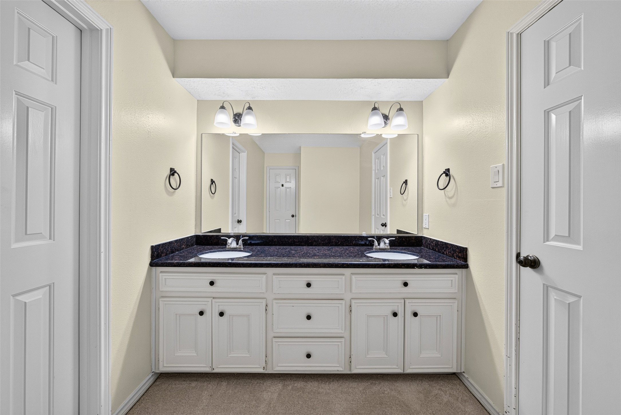 The upstairs bathroom has double sinks and a granite vanity.