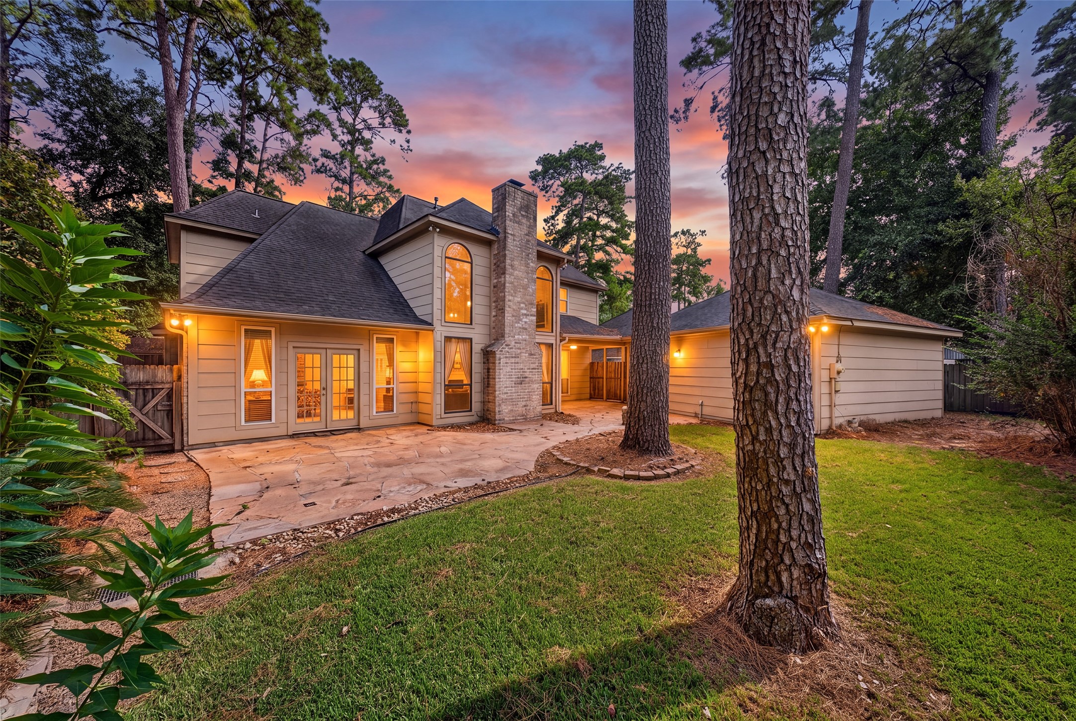 The backyard has lush, low maintenance landscaping and mature pine trees and will be a welcome retreat.