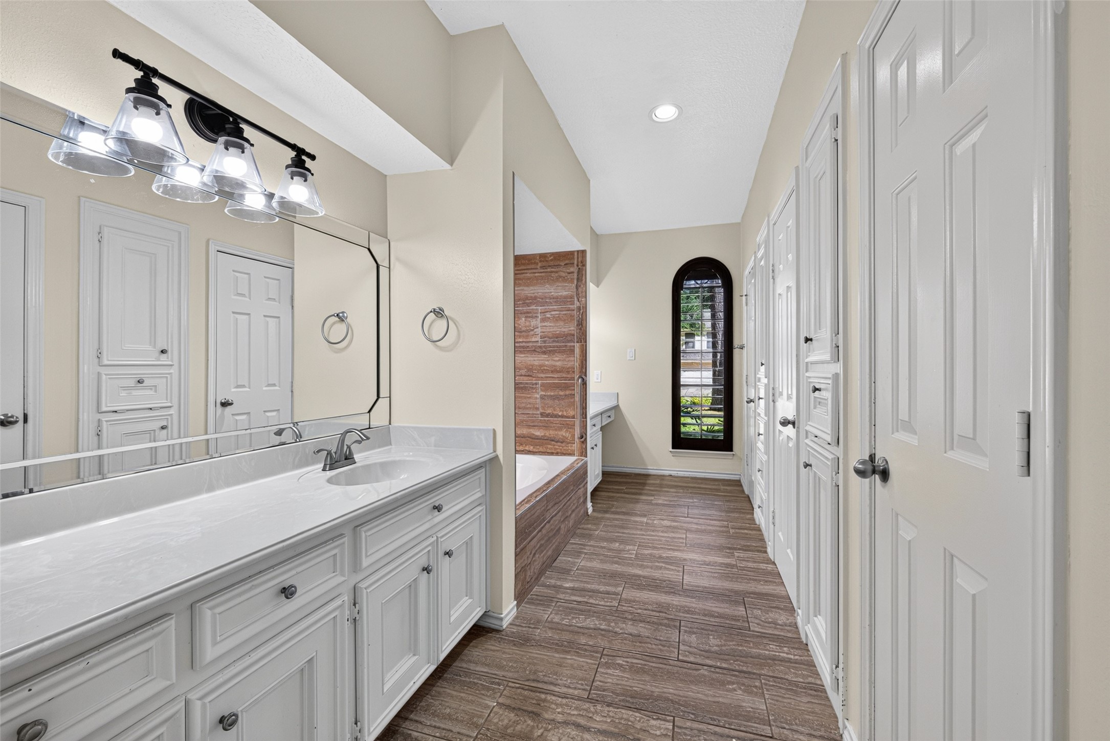 The spacious primary bathroom has dual vanities, 2 walk-in closets, and a private lavatory.