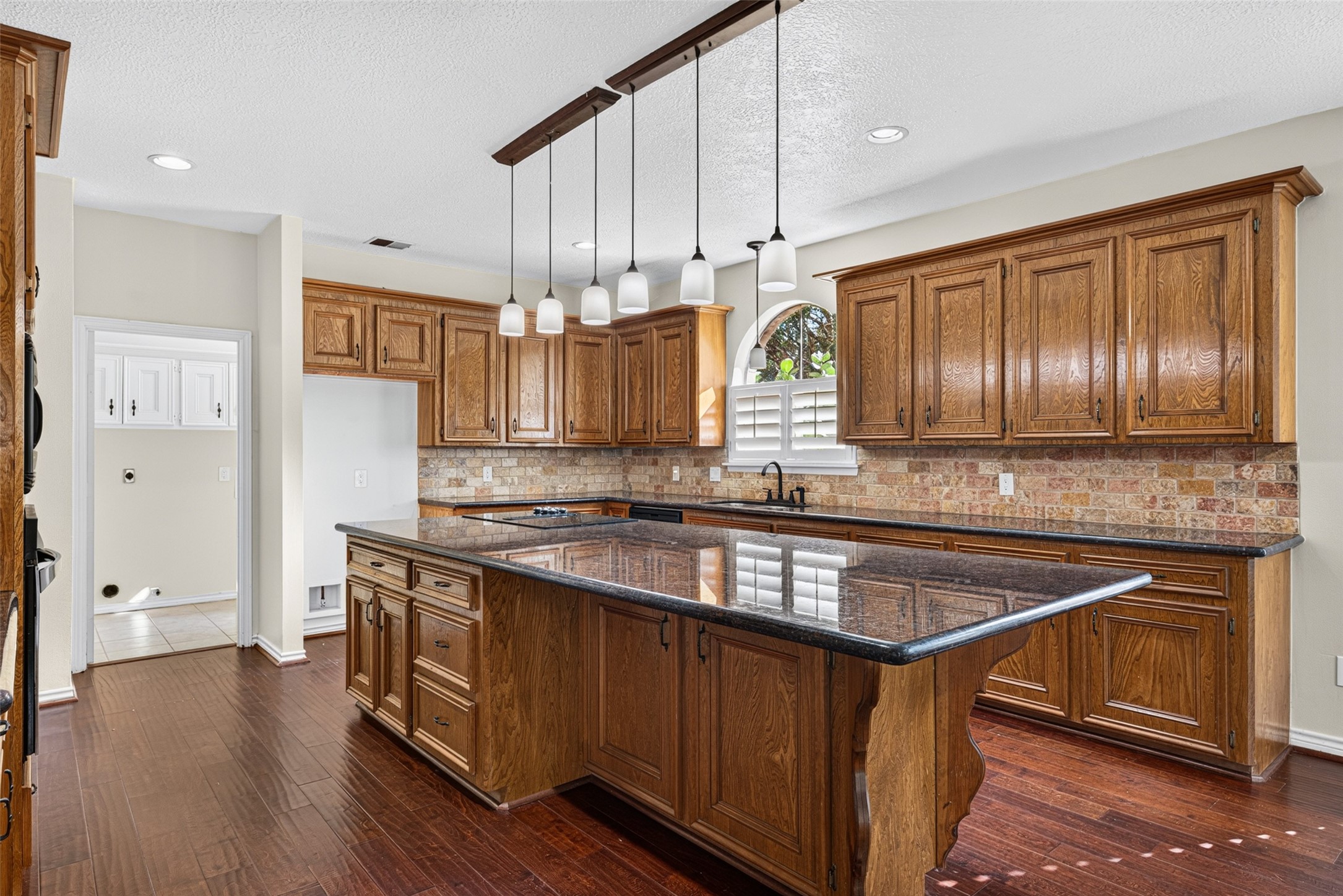 A large granite island is the focal point of the kitchen.