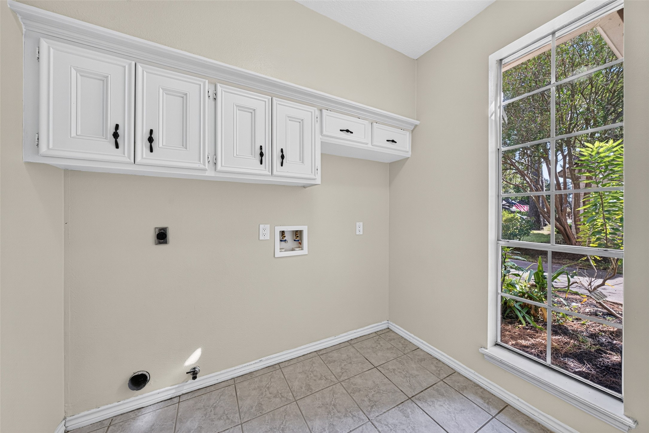 The utility room is spacious and located off of the kitchen.