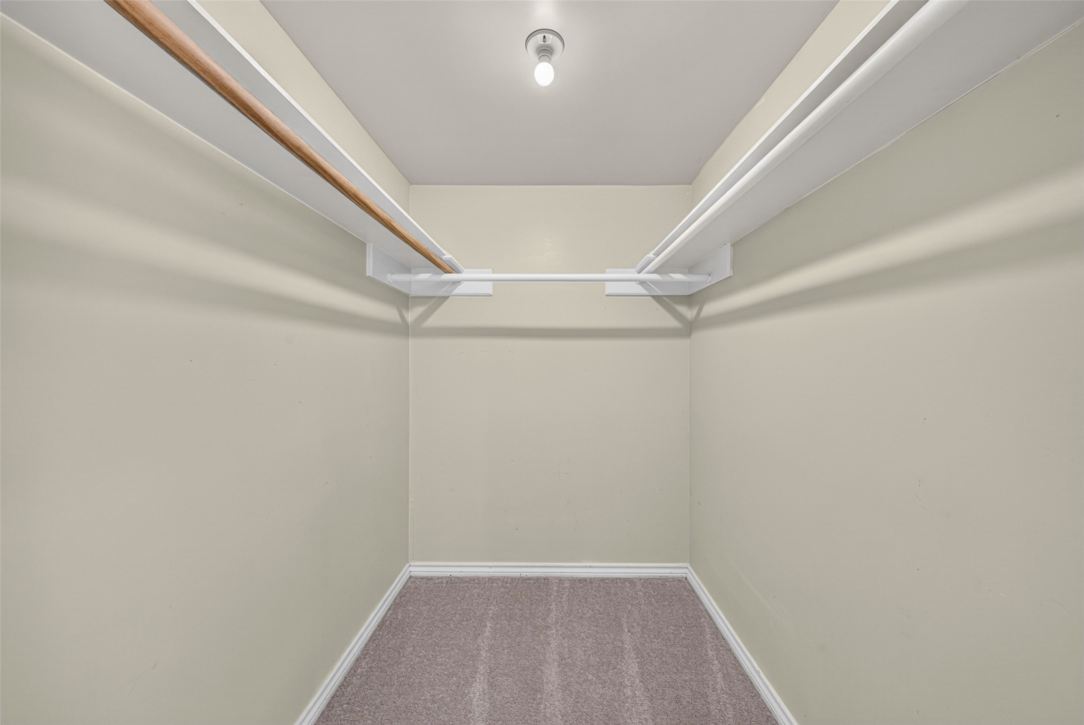 This walk-in closet is in one of the secondary bedrooms. This home is filled with large closets and ample storage space.