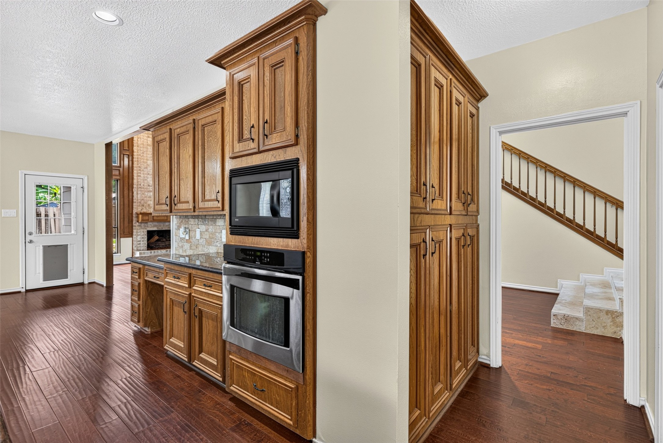 There is additional storage beyond the kitchen in the hallway leading to the dining room.