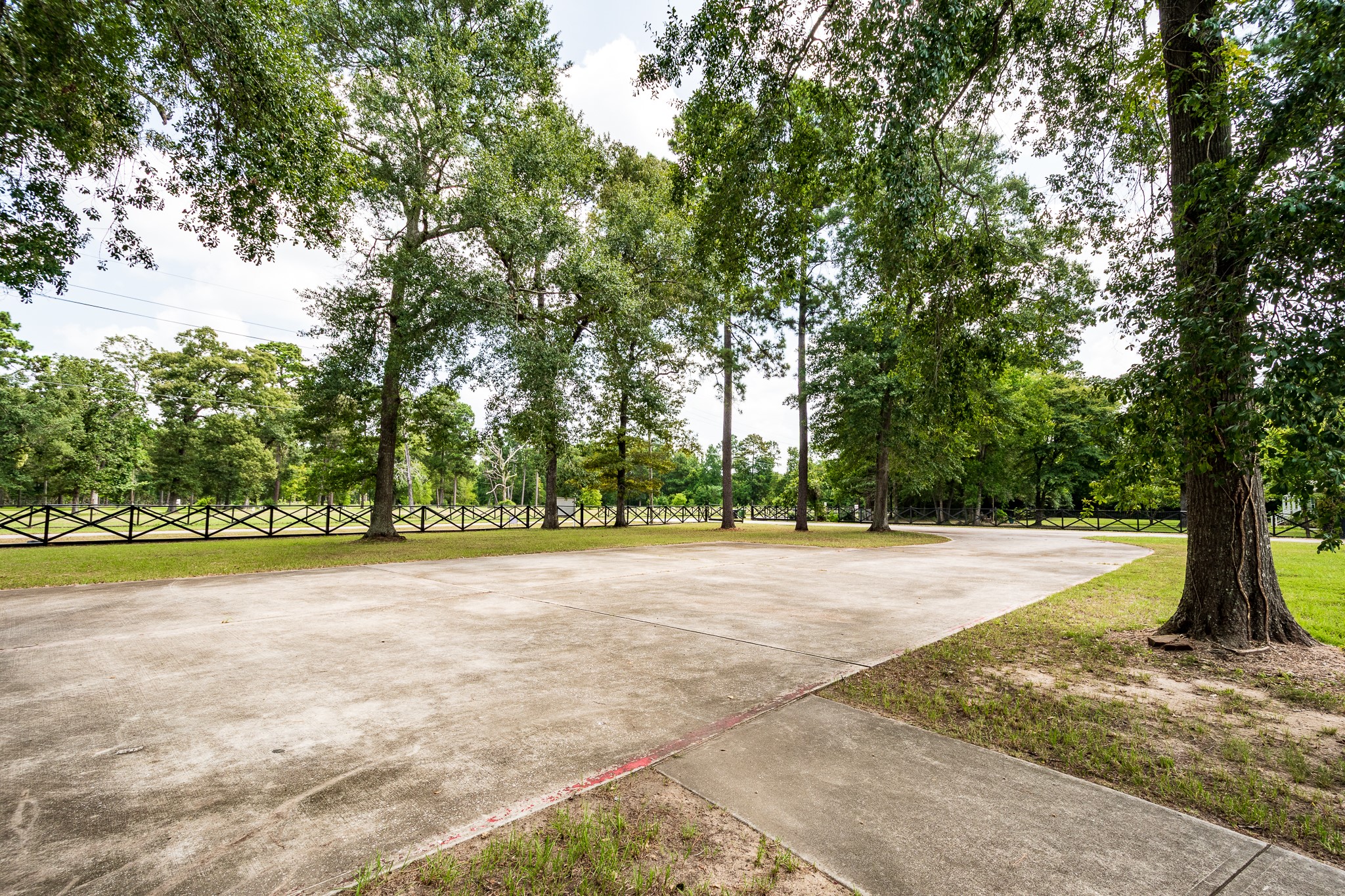 Gorgeous fenced lined driveway of building #3.