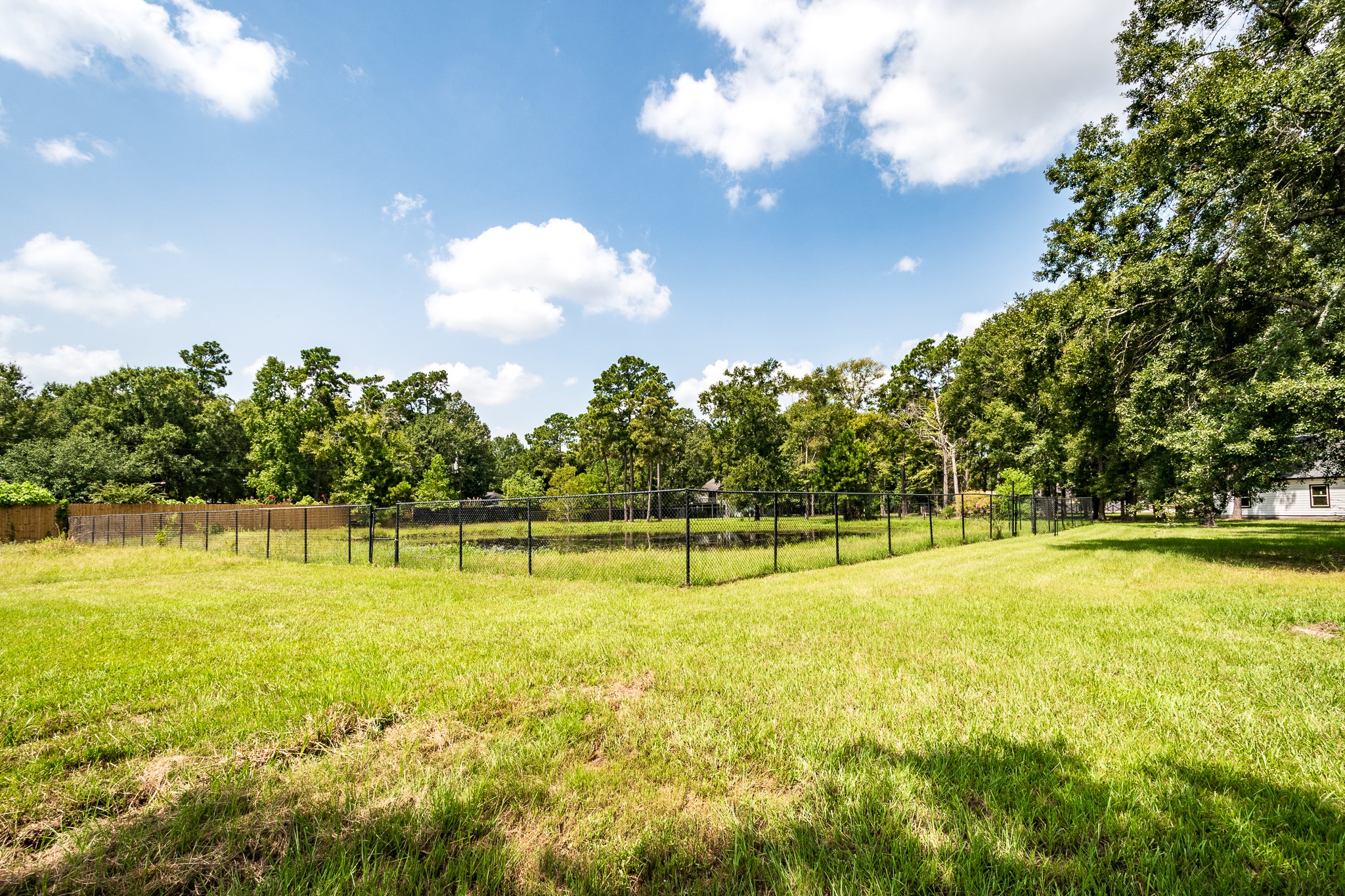 Fenced pond located on south side of Porter Lane 8.5+/-Ac Tract w/ 6 buildings.