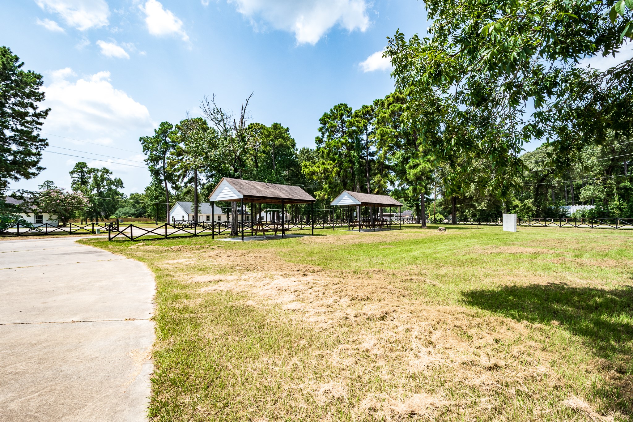 Green space with gazebos and mature trees, perfect for outdoor gatherings and relaxation.