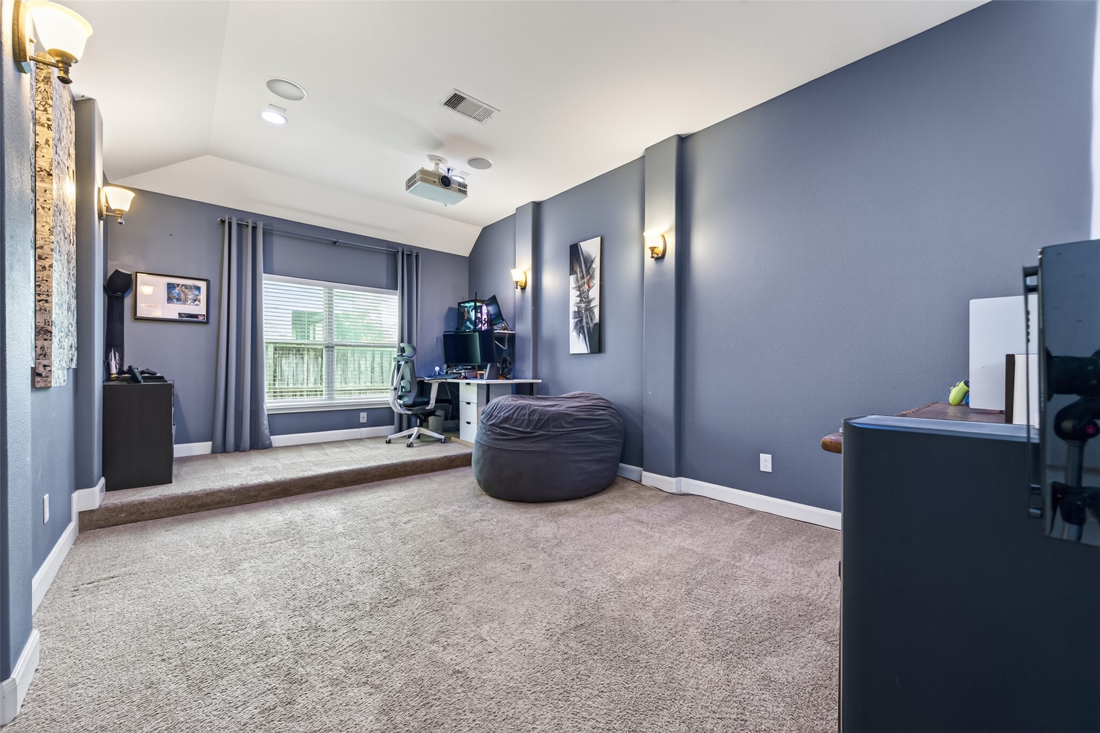 This room has it all to projector mount, pre wire for surround sound, wall sconces, and a silver screen.