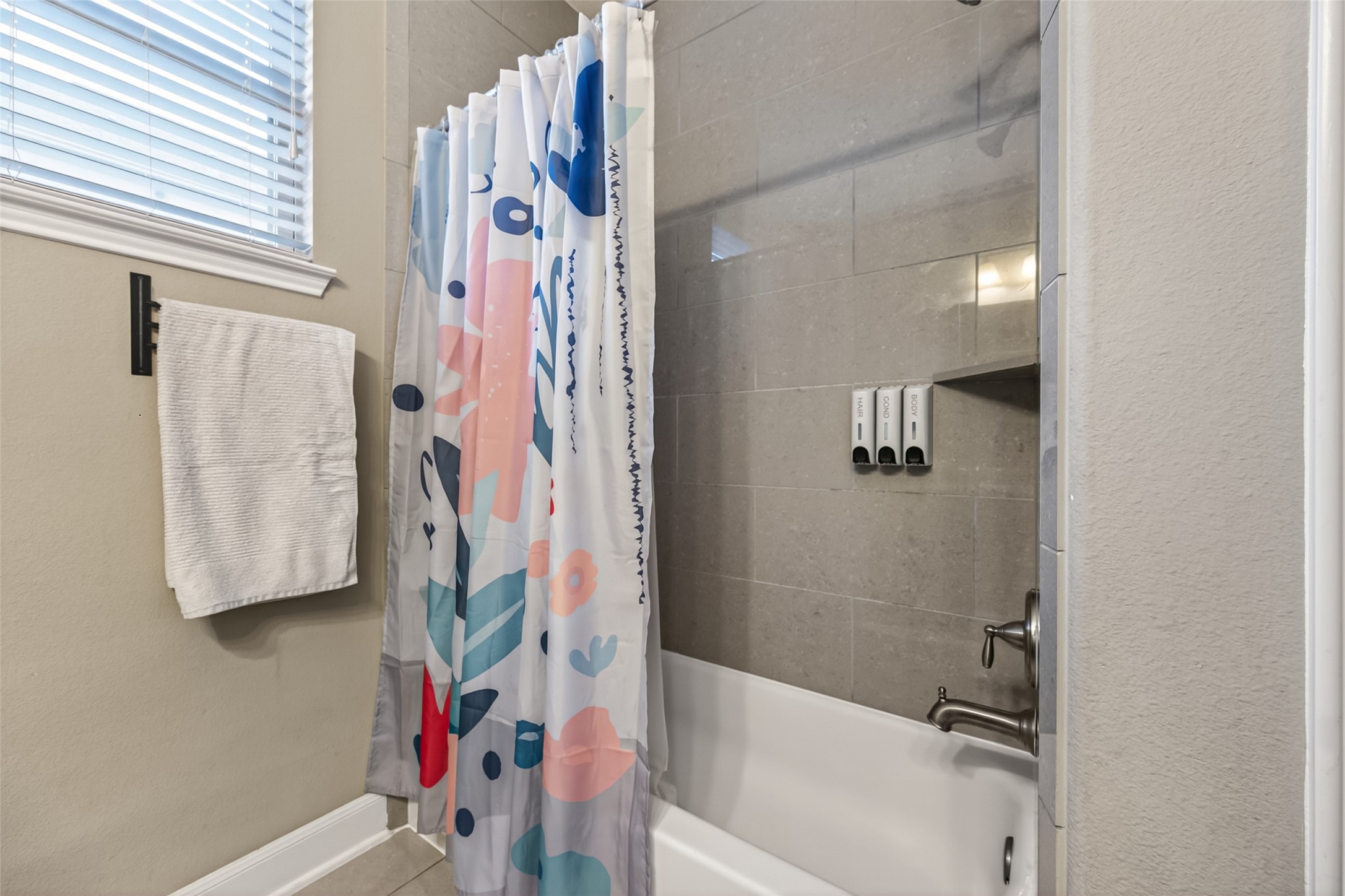 Upgraded tile laid in the shower.