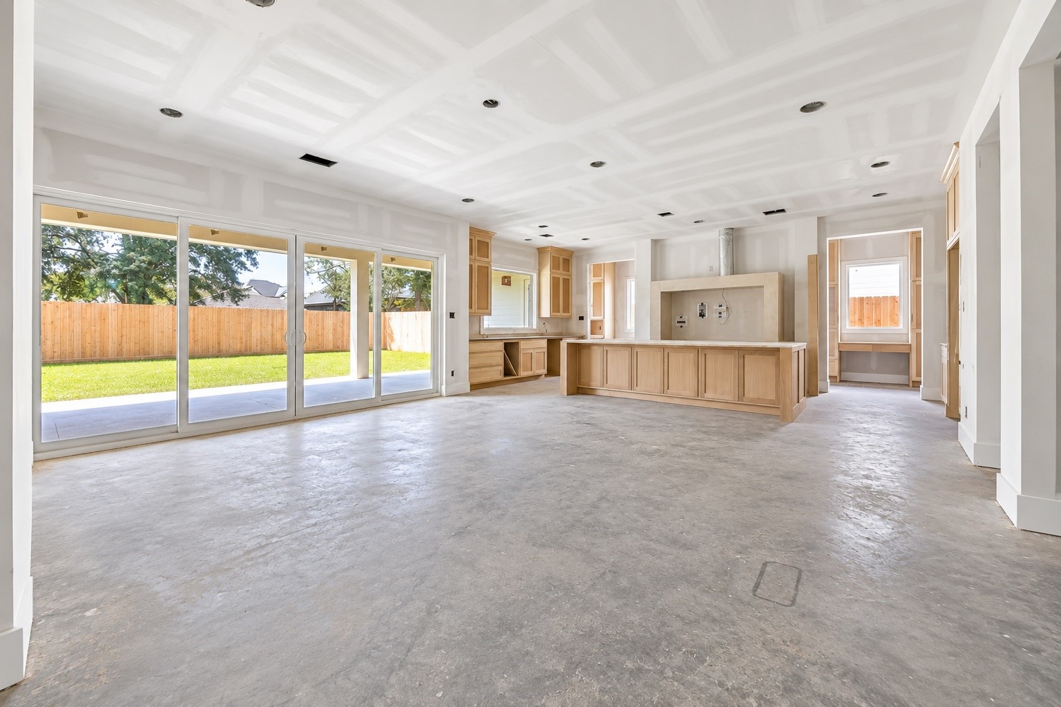 Expansive glass doors fill the open living and kitchen areas with natural light while creating an easy connection to the covered veranda and backyard. Harvard Homes thoughtful layout keeps the oversized island at the center of everyday living and entertaining. **Current Construction as of 9/11/26