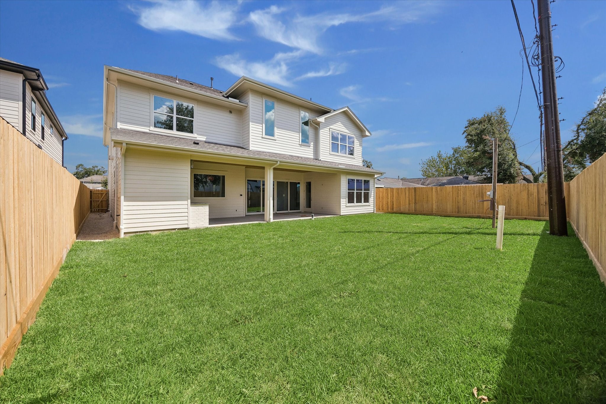 A spacious fenced backyard creates plenty of room for a future pool, play space, and outdoor entertaining. The deep covered patio extends the living space outdoors with direct access from the main living area. **Current Construction as of 9/11/26