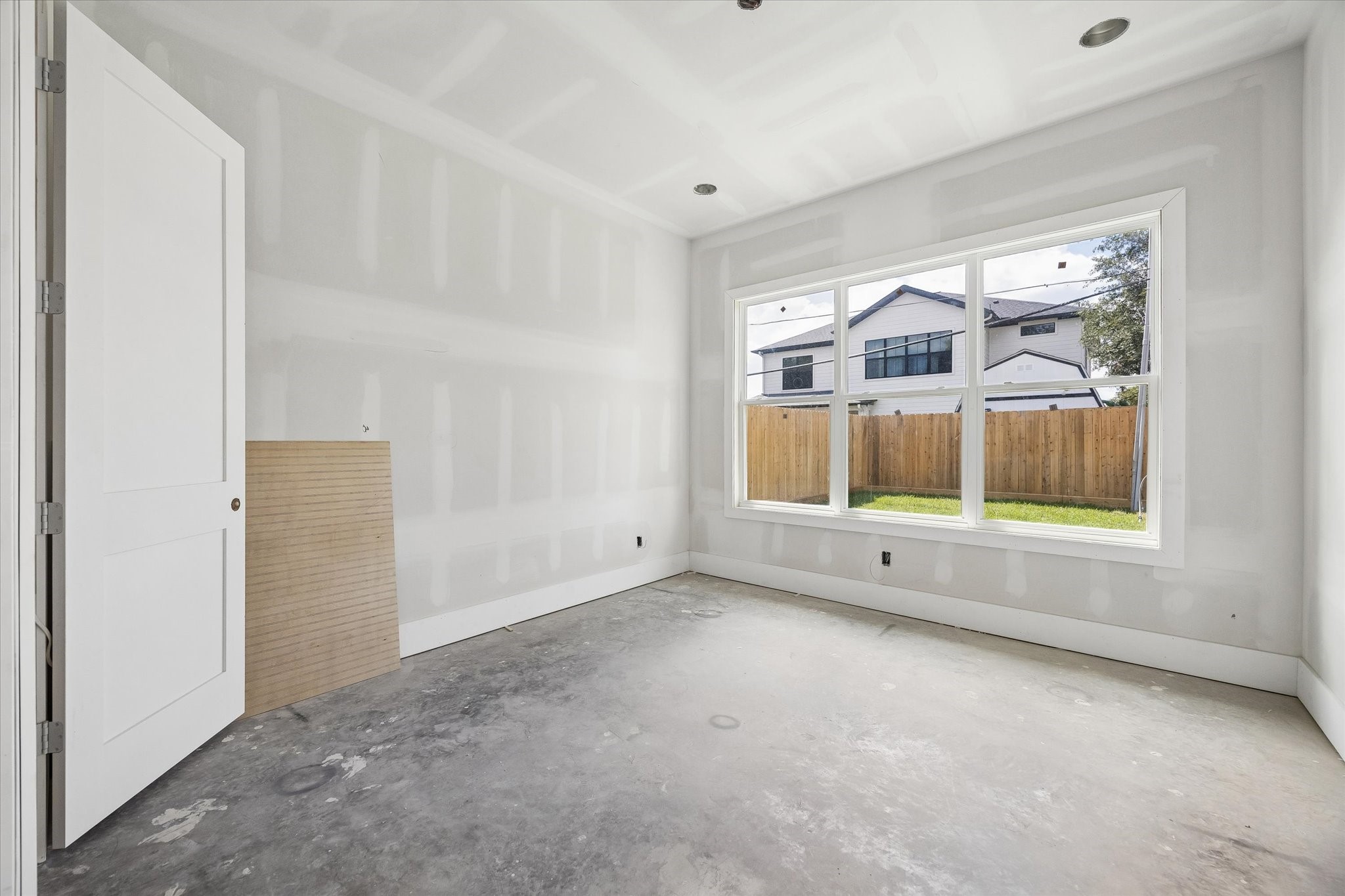 Downstairs guest bedroom offers a private retreat with a wide window overlooking the backyard and bringing in abundant natural light. Its first floor location creates comfortable separation from the upstairs bedrooms. **Current Construction as of 9/11/26