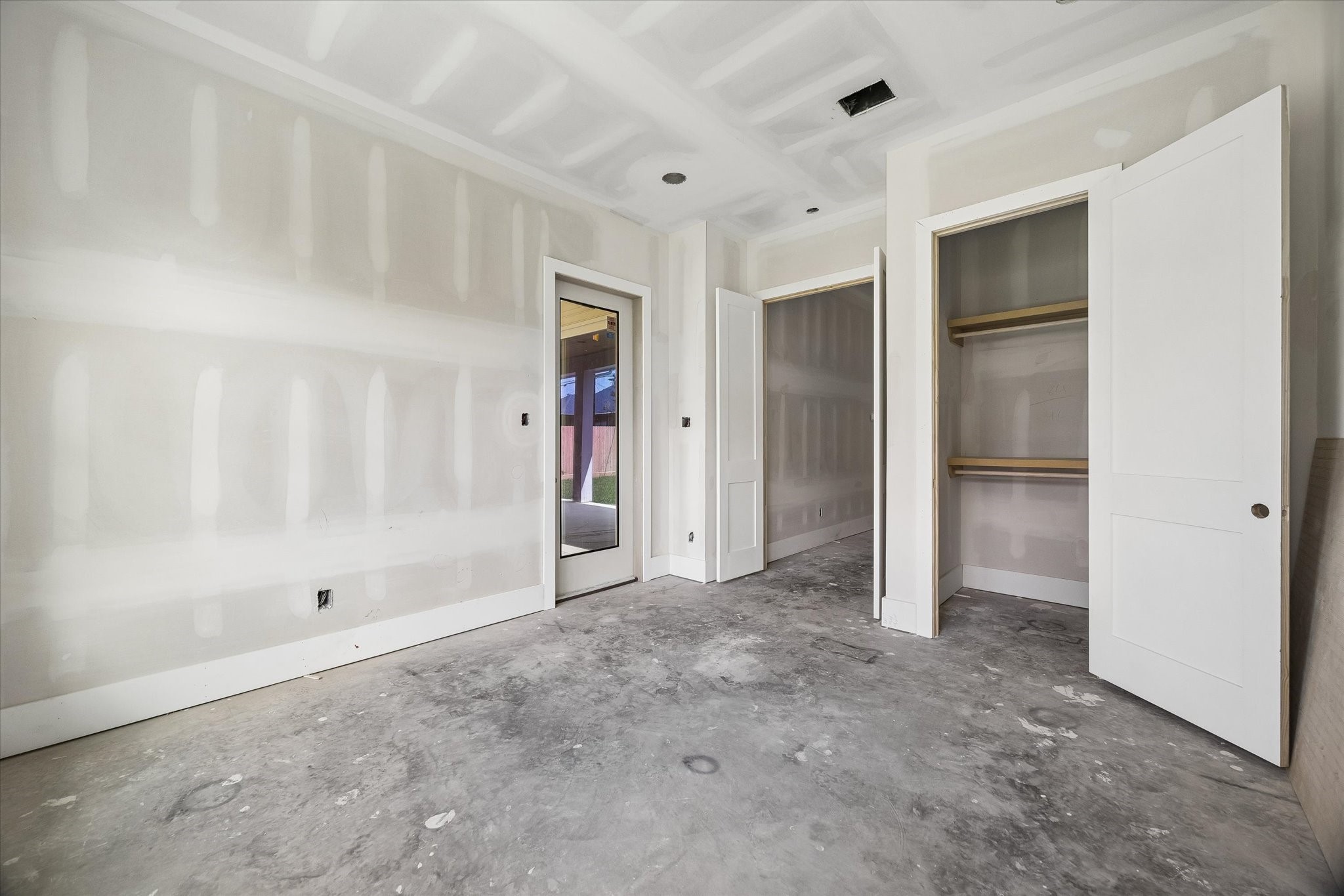 Alternate view highlights the downstairs guest suites generous storage with dual closets and convenient access to the covered back patio. Thoughtful placement creates an ideal setup for overnight guests with added privacy. **Current Construction as of 9/11/26