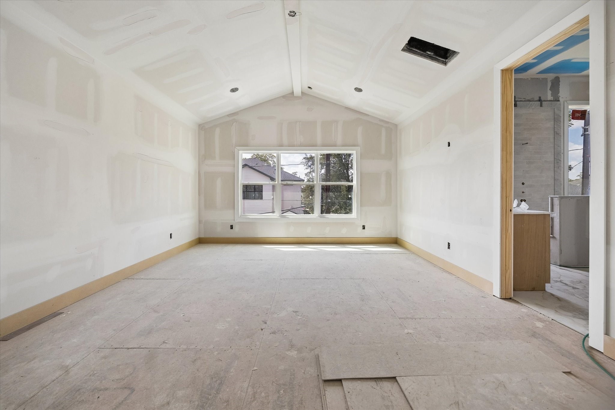 Vaulted ceilings add volume and architectural interest to the spacious primary suite, while a wide bank of windows fills the room with natural light. Direct access to the ensuite creates an easy, private retreat. **Current Construction as of 9/11/26