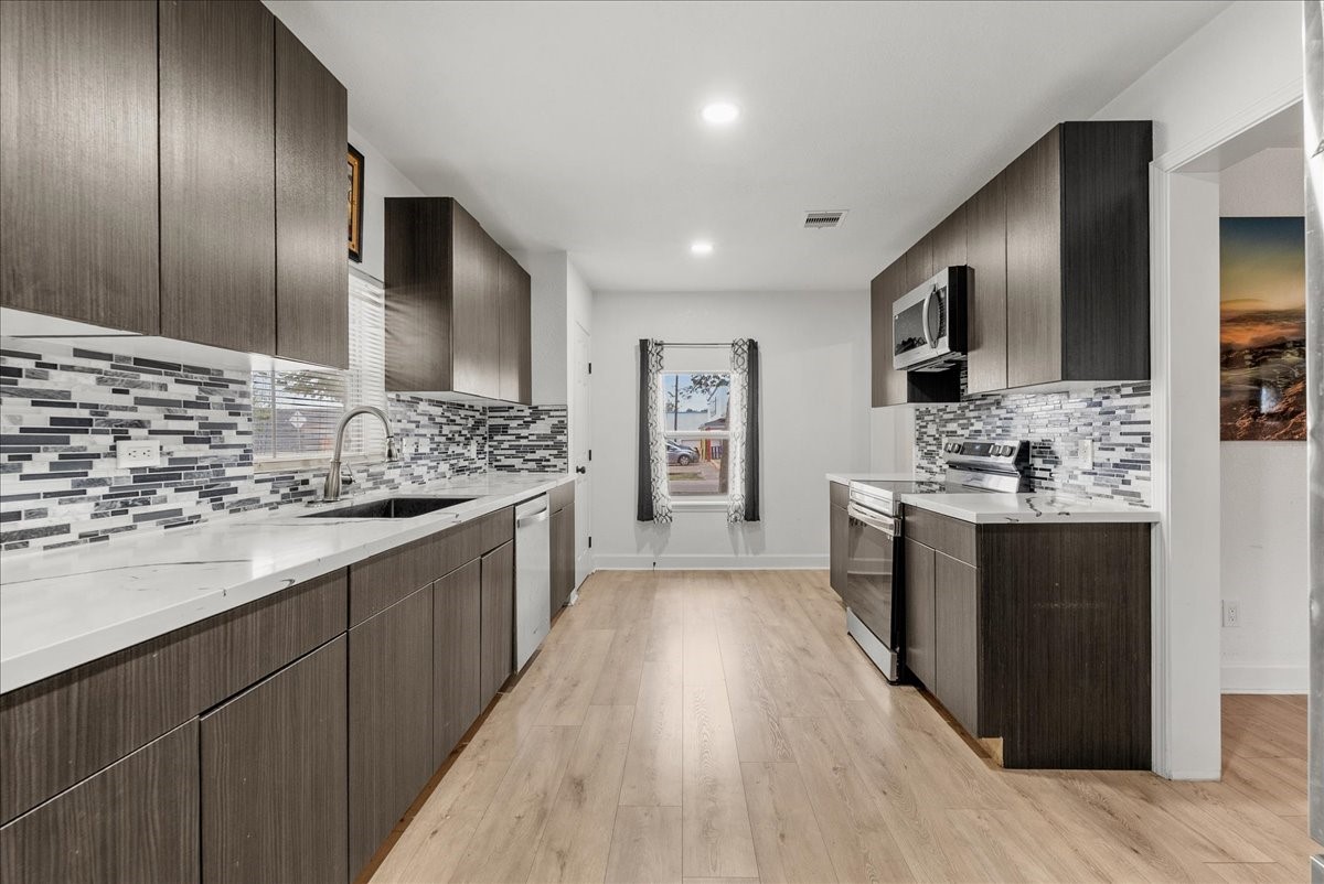 A cozy, updated kitchen featuring a timeless blend of black, white, and gray tones. Thoughtful finishes create a clean, modern look while keeping the space warm and inviting. A cozy, updated kitchen featuring a timeless blend of black, white, and gray tones. Thoughtful finishes create a clean, modern look while keeping the space warm and inviting.