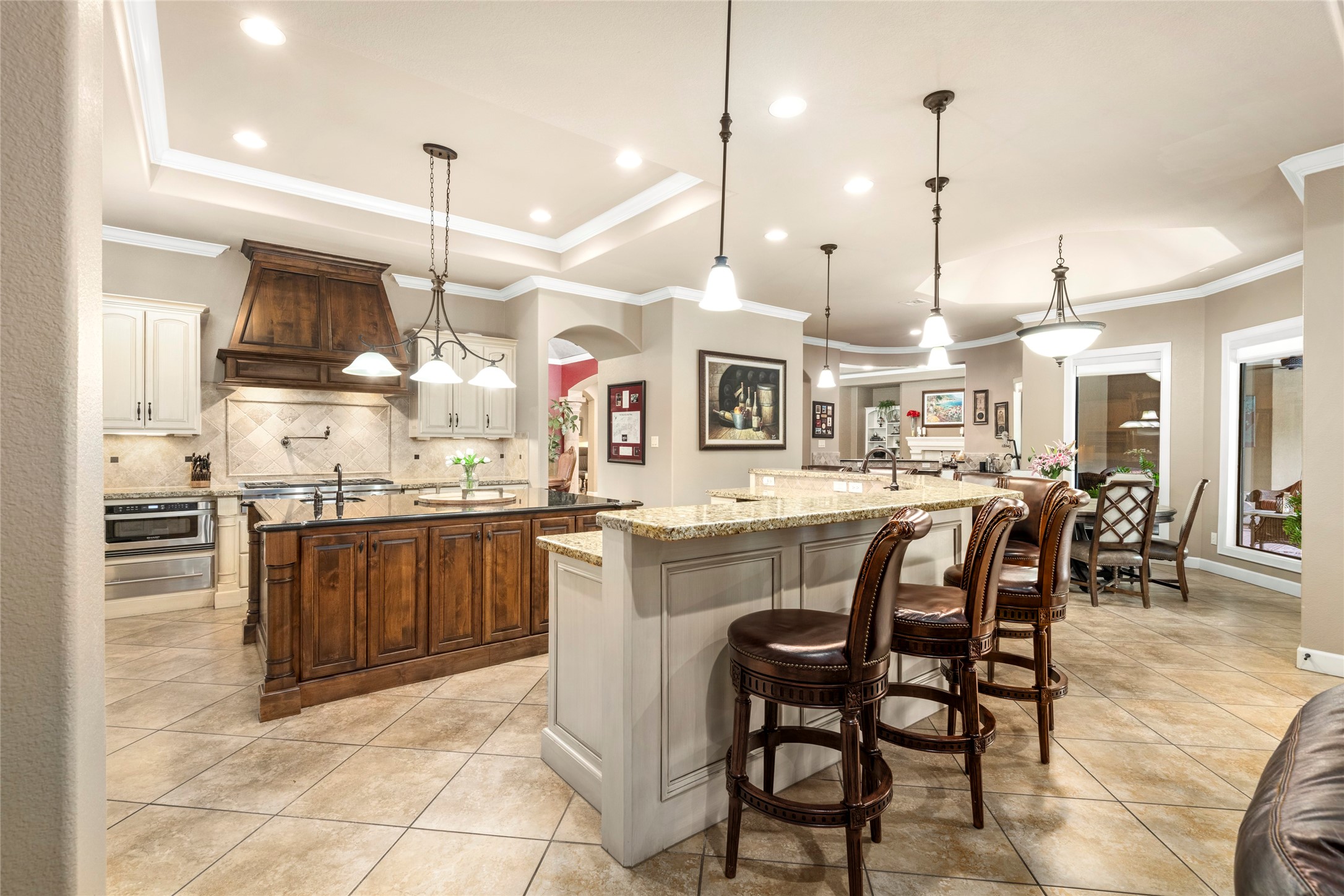 The kitchen showcases oversized detail, a huge island & breakfast bar, and gourmet finishes ideal for casual meals and entertaining.