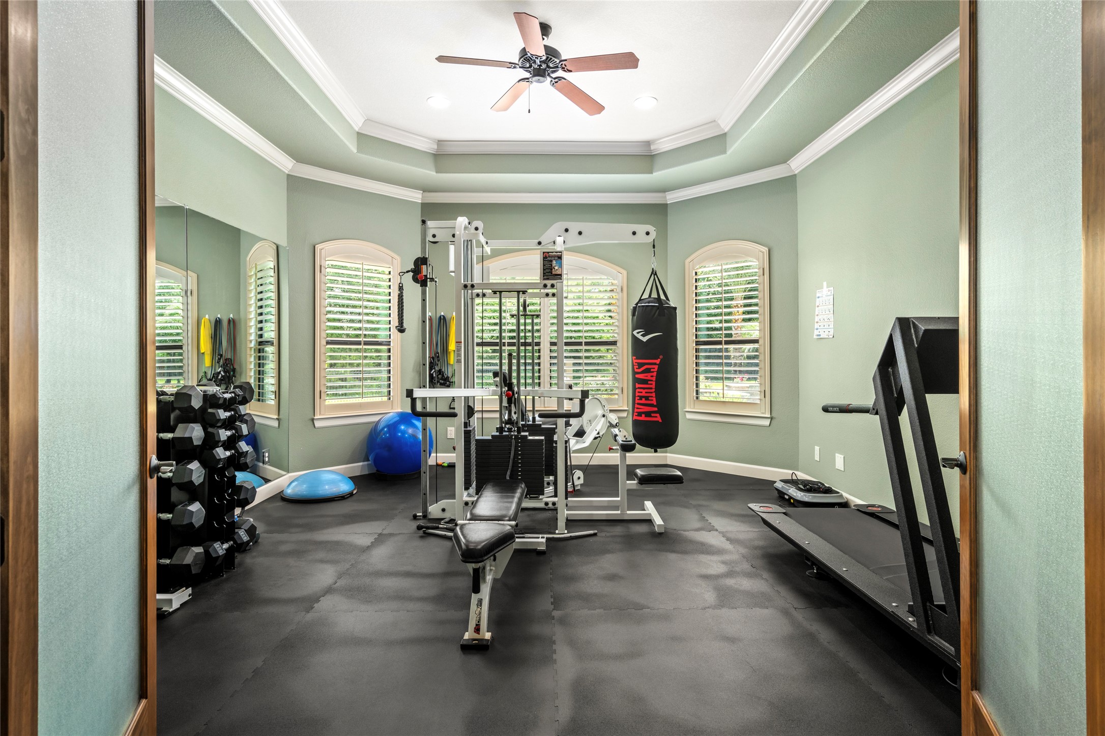 The flex space is set up as a home gym, conveniantly arranged to make workouts easy and enjoyable.