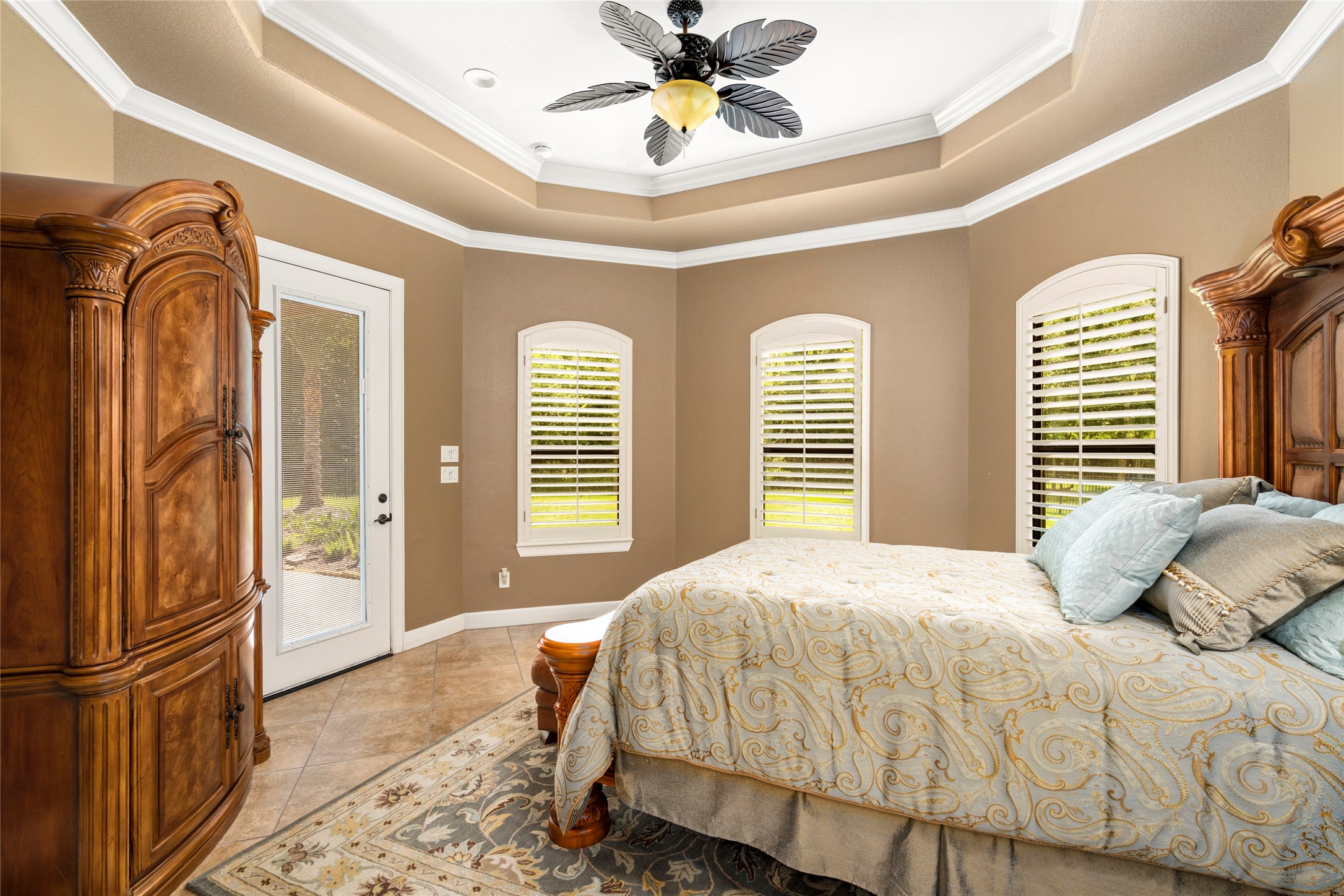 Private guest suite with direct pool access, a wall of windows with wood shutters, tile floors, and generous space for comfortable stays.