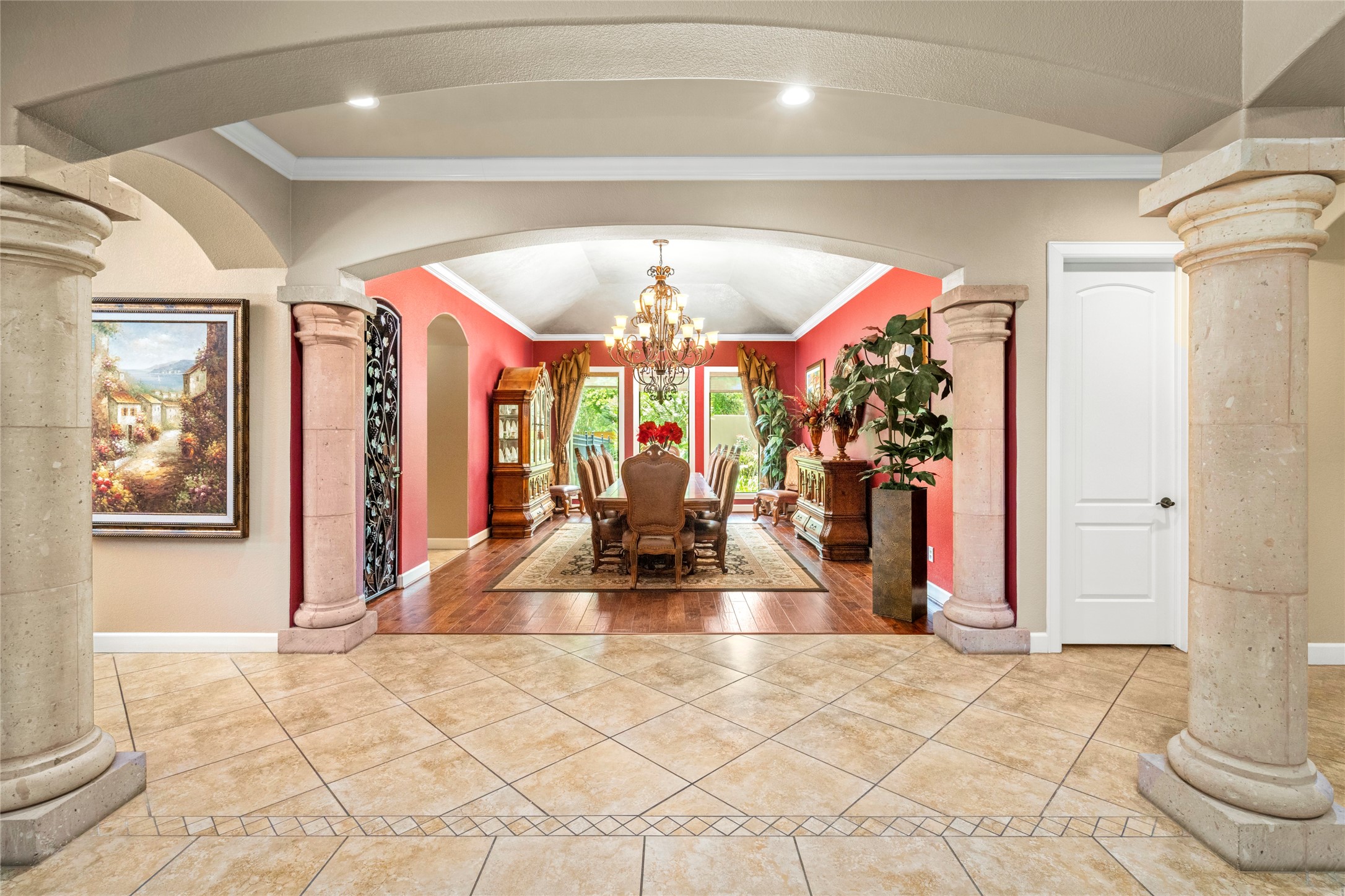 This grand dining room with seating for 12, a wall of windows, and a wine room offers a warm intimate setting for memorable gatherings.