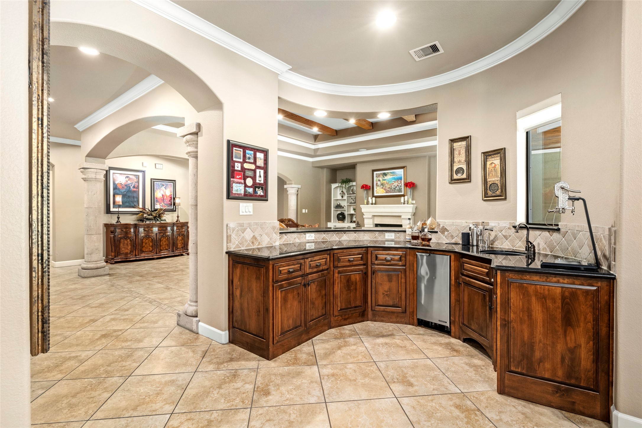 The large wet bar area can double as a convenient serving station, perfectly situated for effortless entertaining.