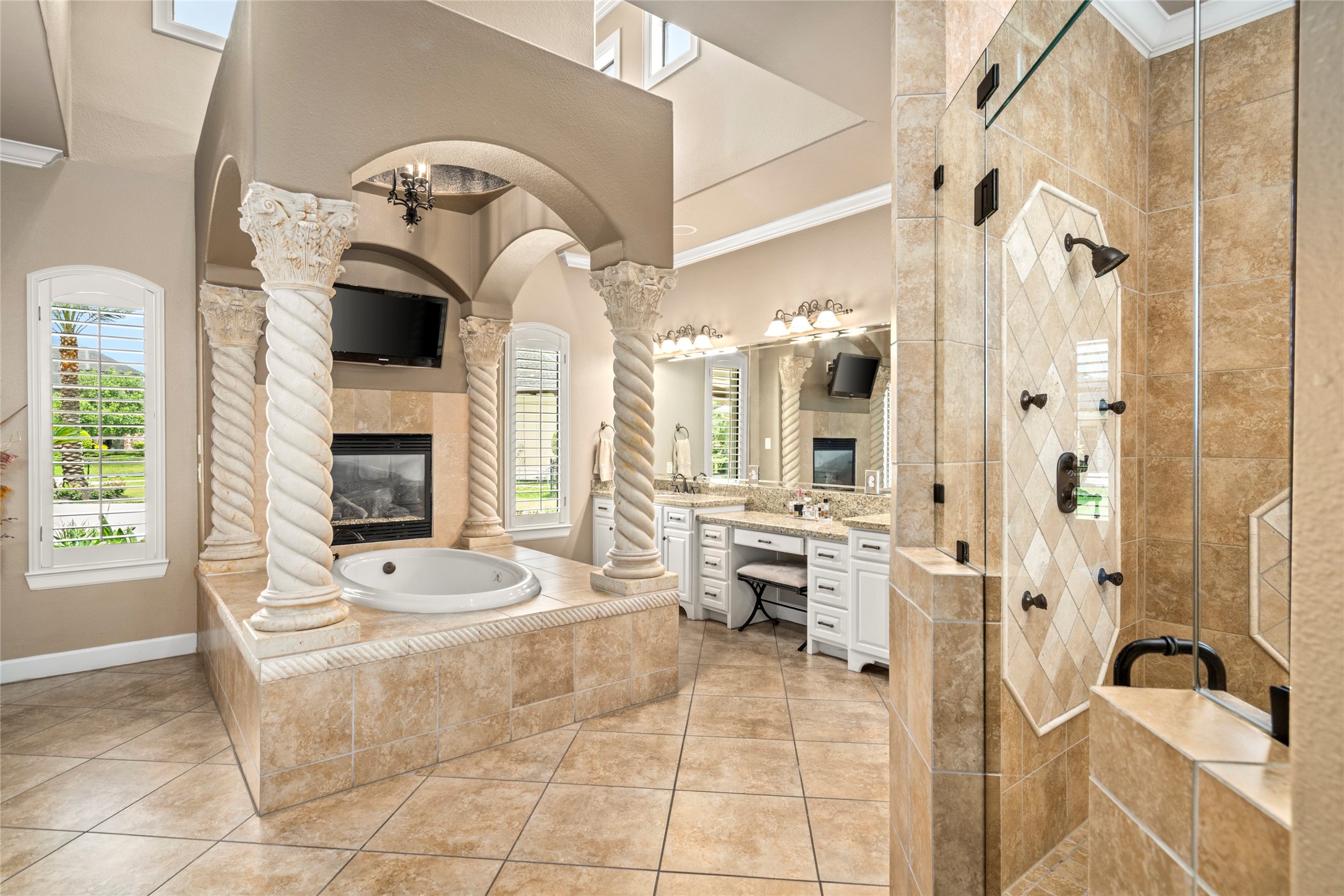 Primary bath features a fireplace for relaxing soaks, abundant natural light, elegant stone columns flanking the tub, and beautiful fine crafted finishes throughout. This suite is a pampering retreat that will delight even the most spoiled.