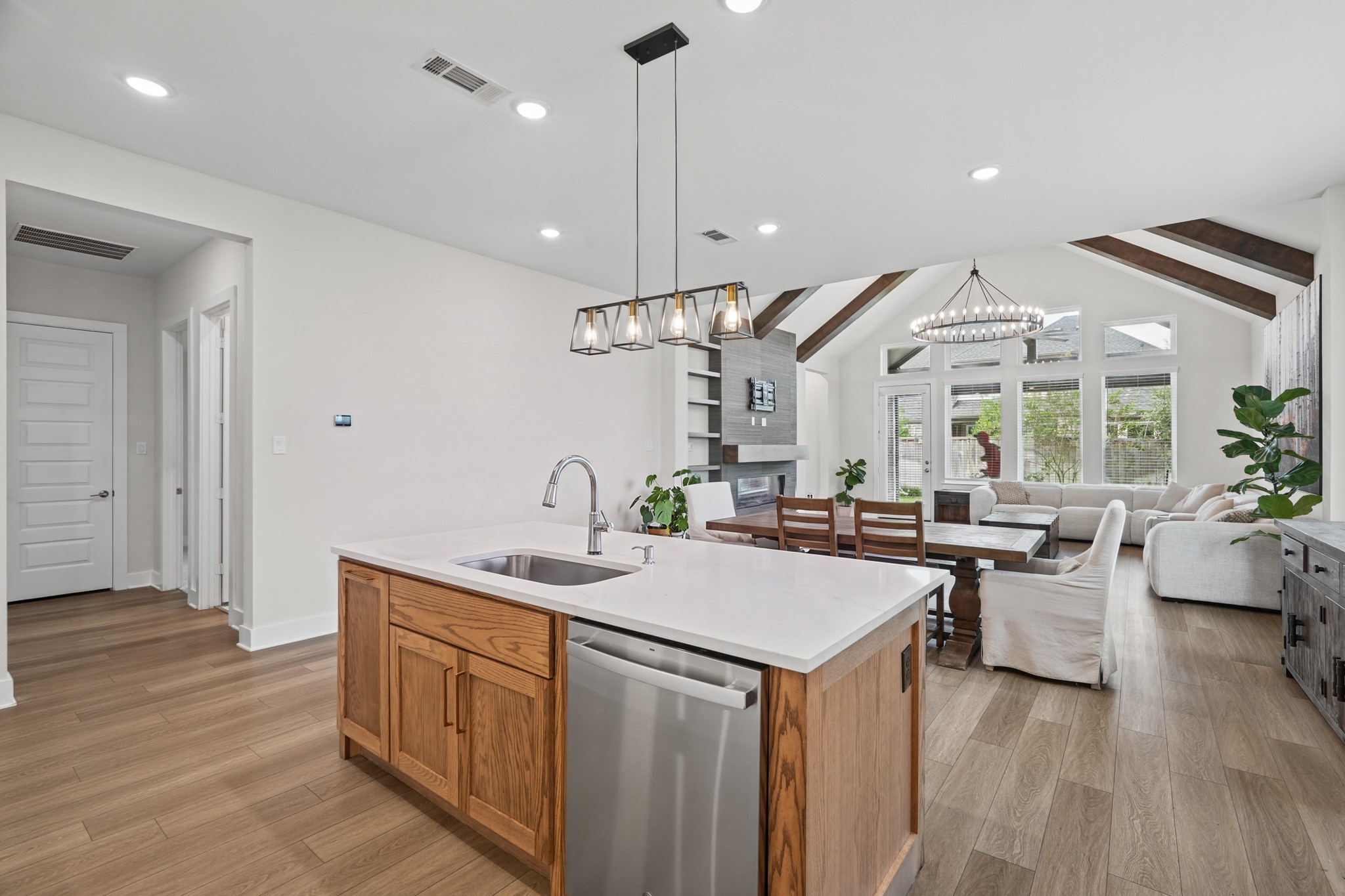 From the sink and dishwasher run, the kitchen looks straight through to the beamed living room - ideal for keeping company with family and guests while you are cooking.