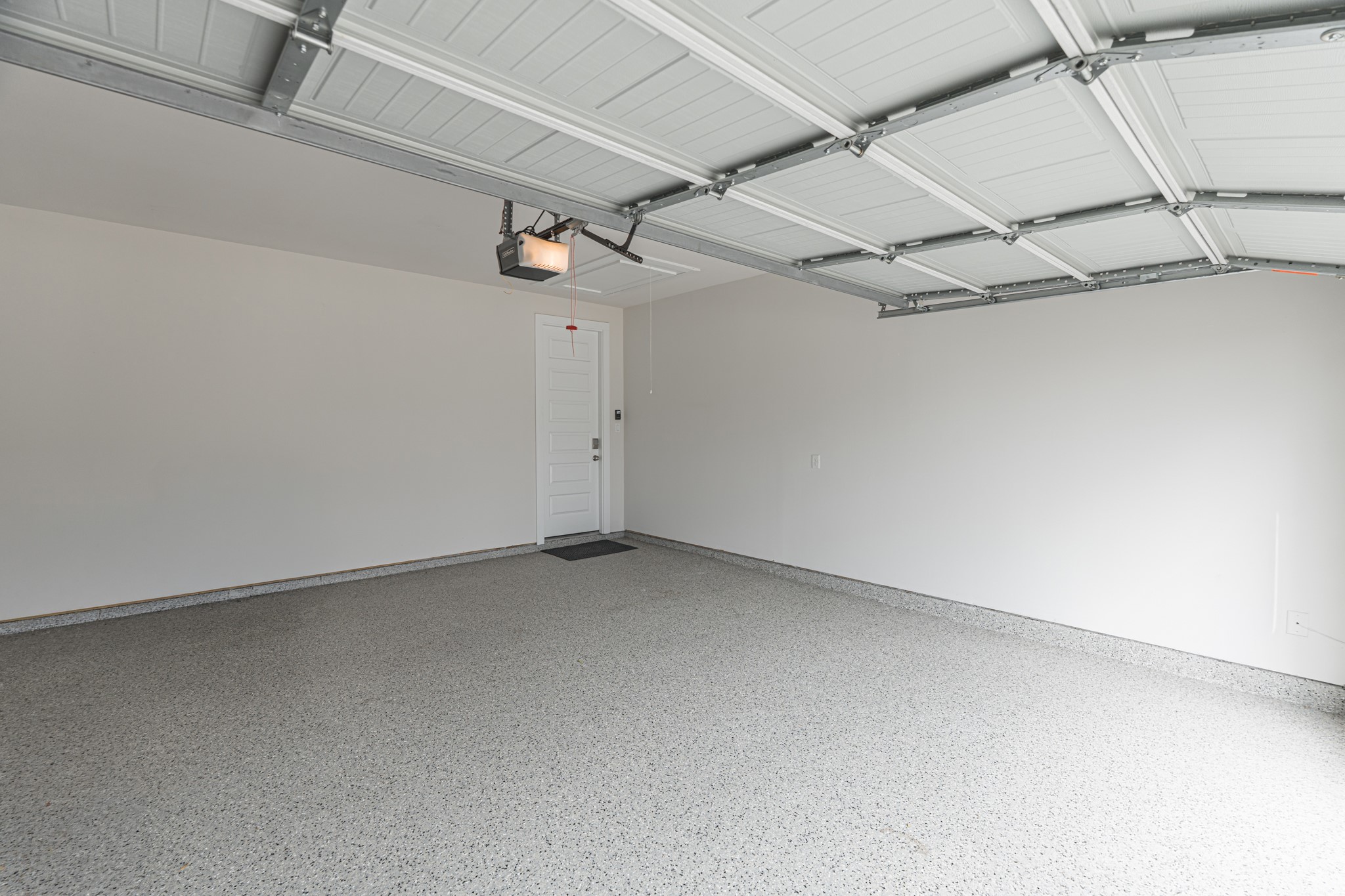 Two-car attached garage with a finished floor and room for vehicles plus storage, opening conveniently into the home near the laundry room and kitchen entry.