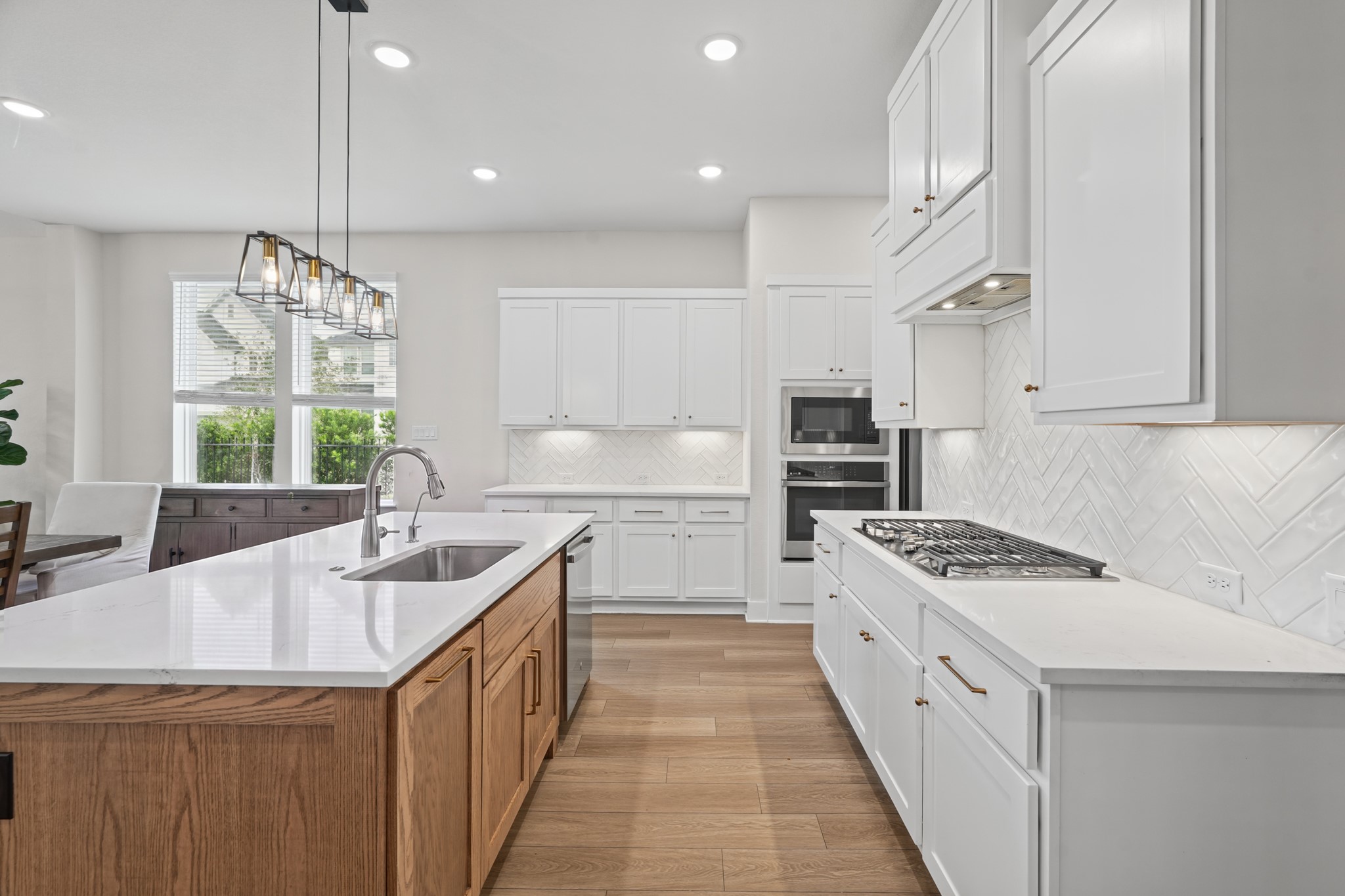 The kitchen workspace runs the length of the wall with abundant cabinetry, a long counter run and room for more than one cook - thoughtfully laid out for everyday function.