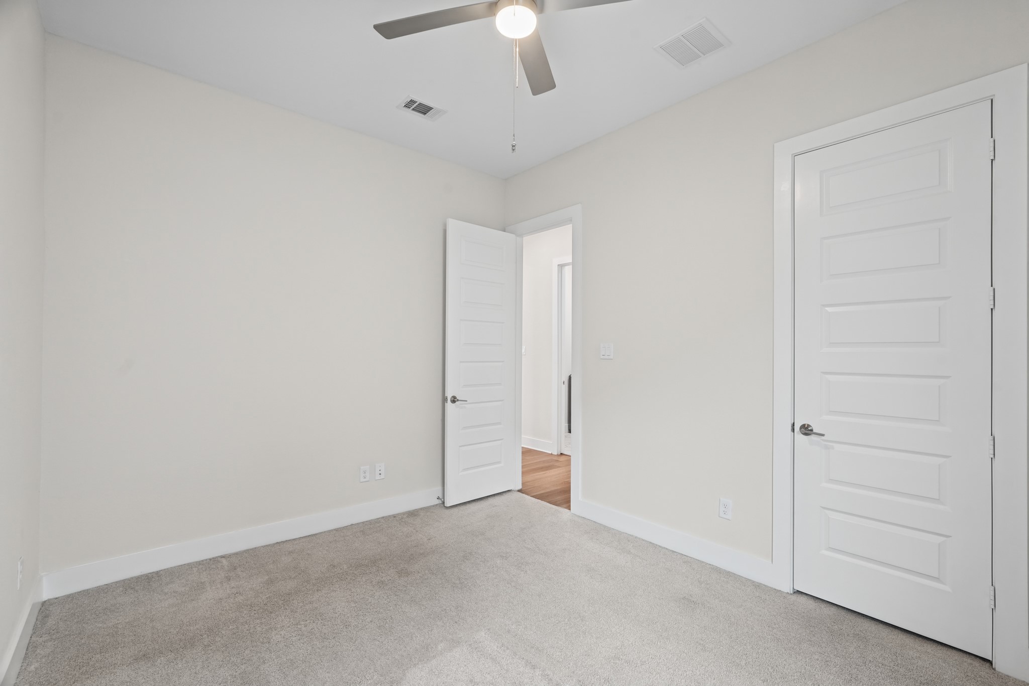 A third secondary bedroom sits on its own side of the plan, offering real privacy from the primary suite along with closet storage and a full bath just steps away.