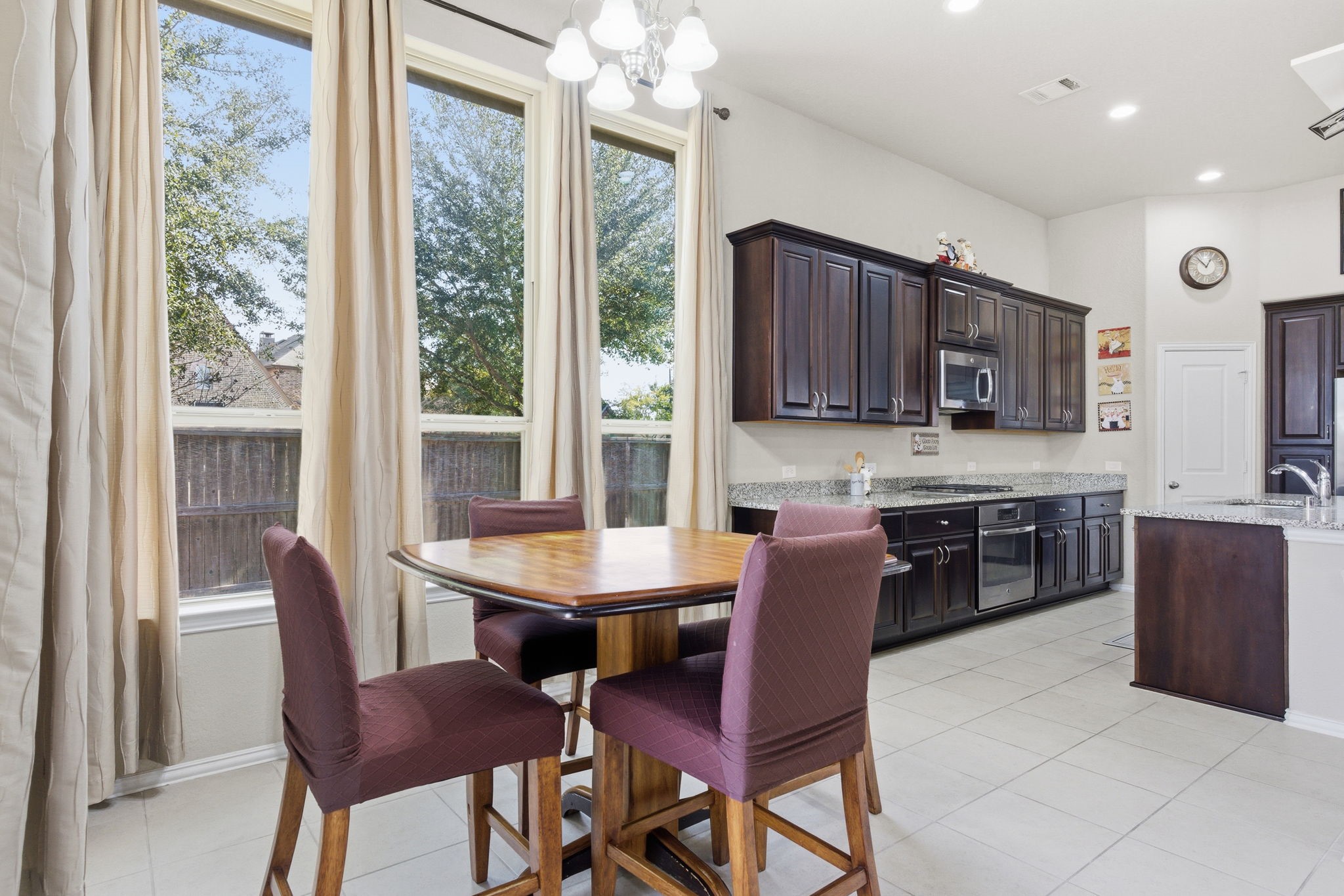 Kitchen and breakfast area surrounded by large windows boastings tons of natural light.