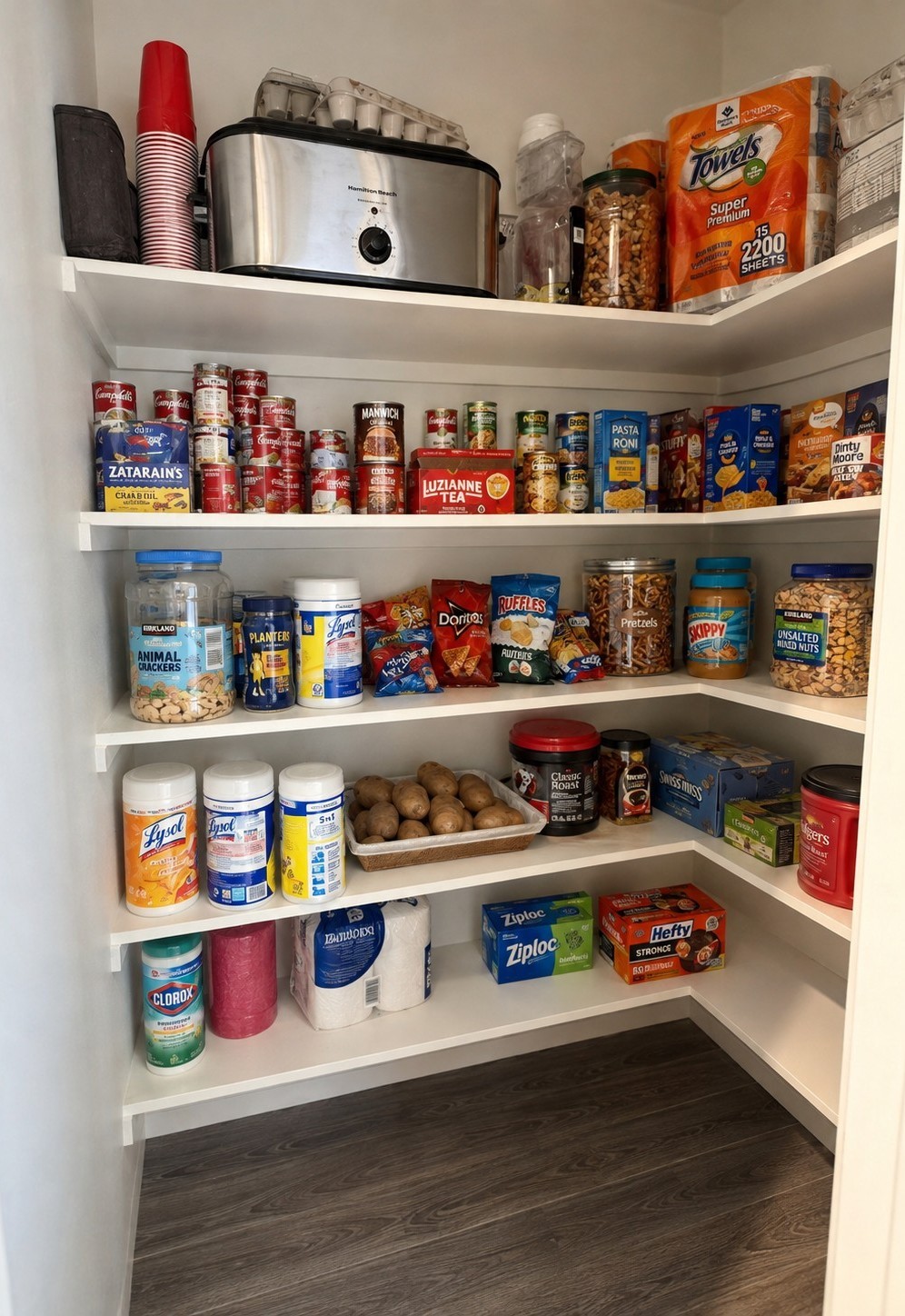 Spacious pantry with wraparound shelving provides abundant storage.