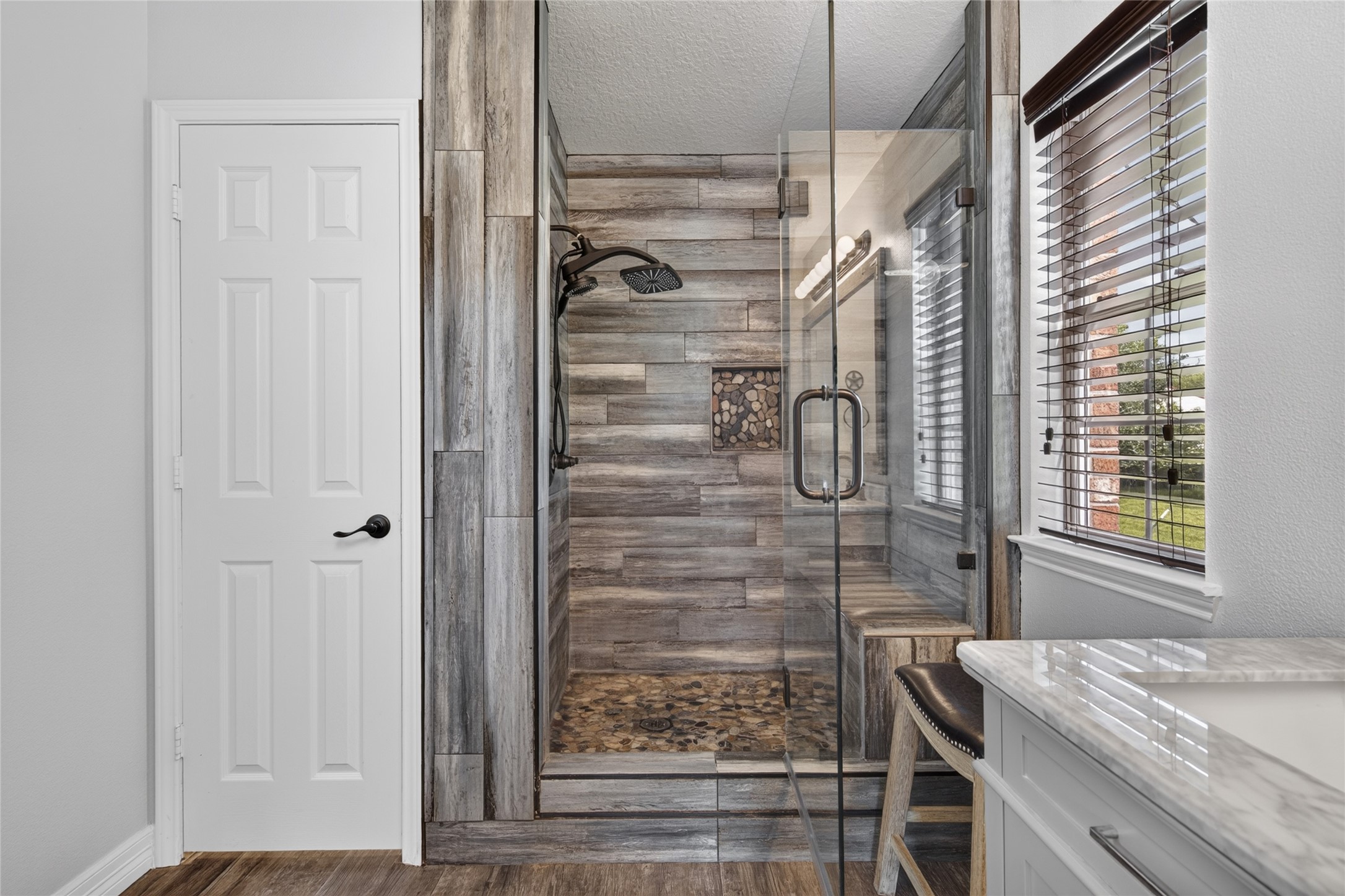 Custom shower, built-in bench, and shower niche.