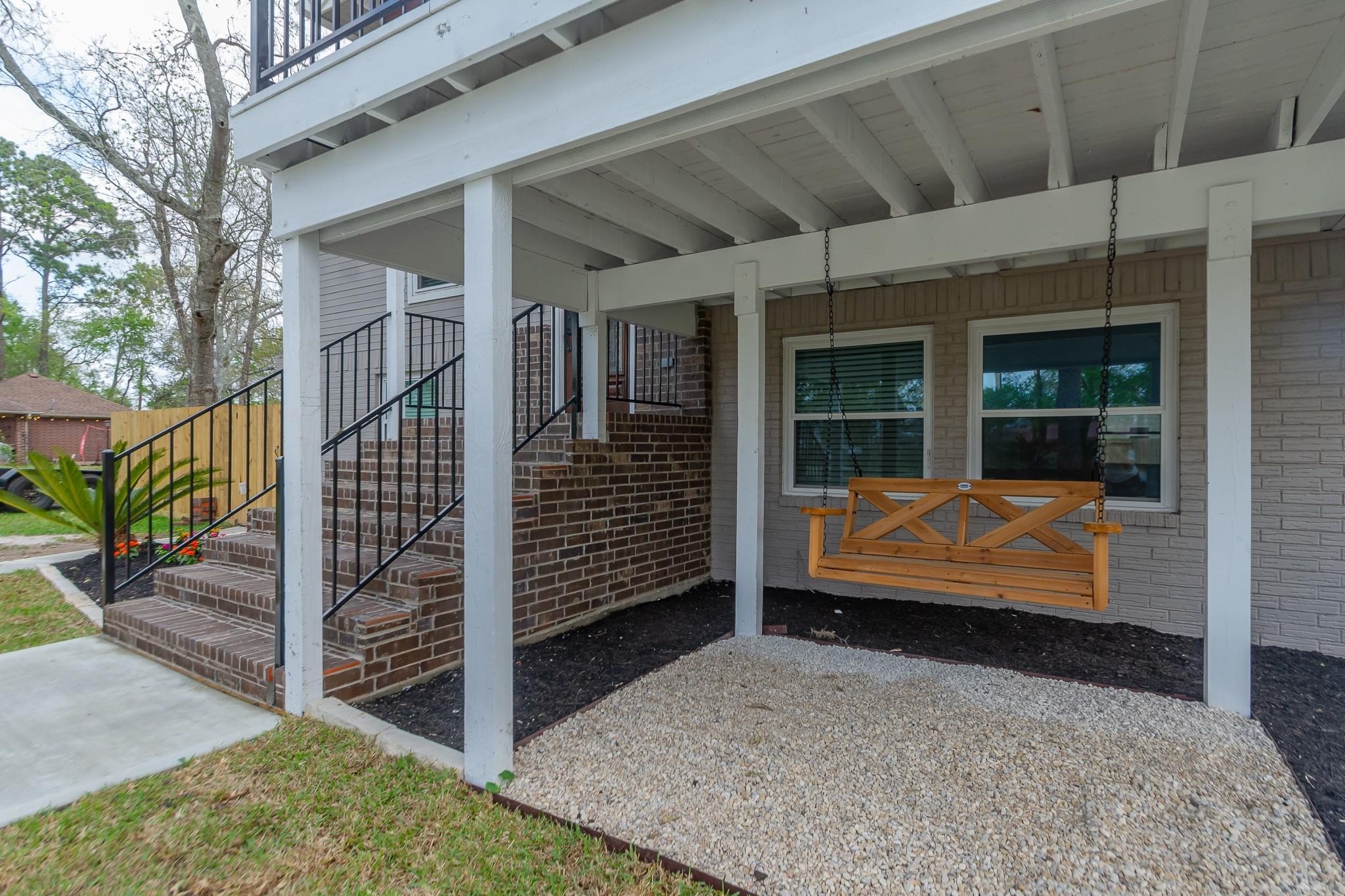 A shaded, covered area with a porch swing, tucked neatly under the deck.