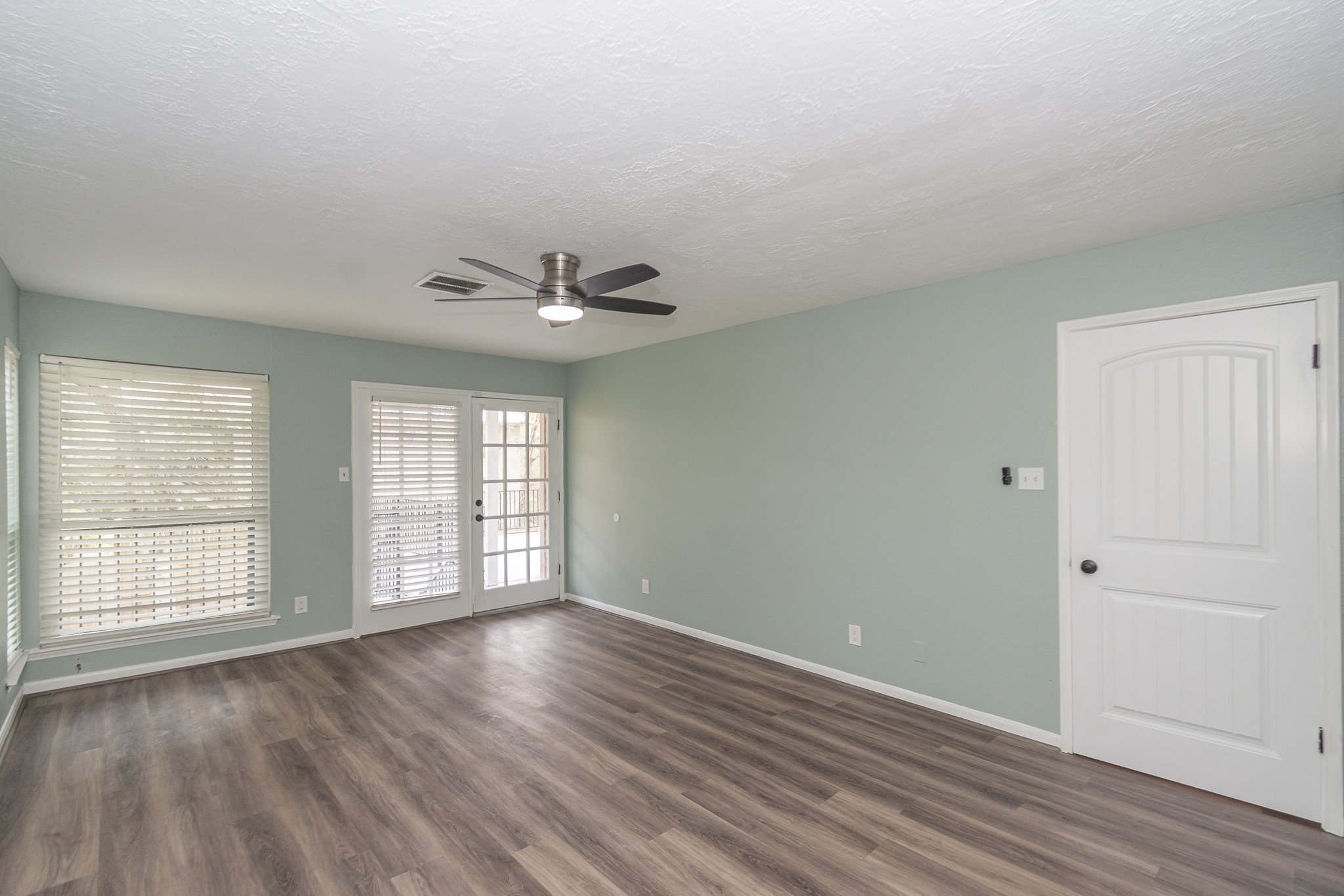 2nd view of the primary bedroom with an access door to the back 2nd floor deck.