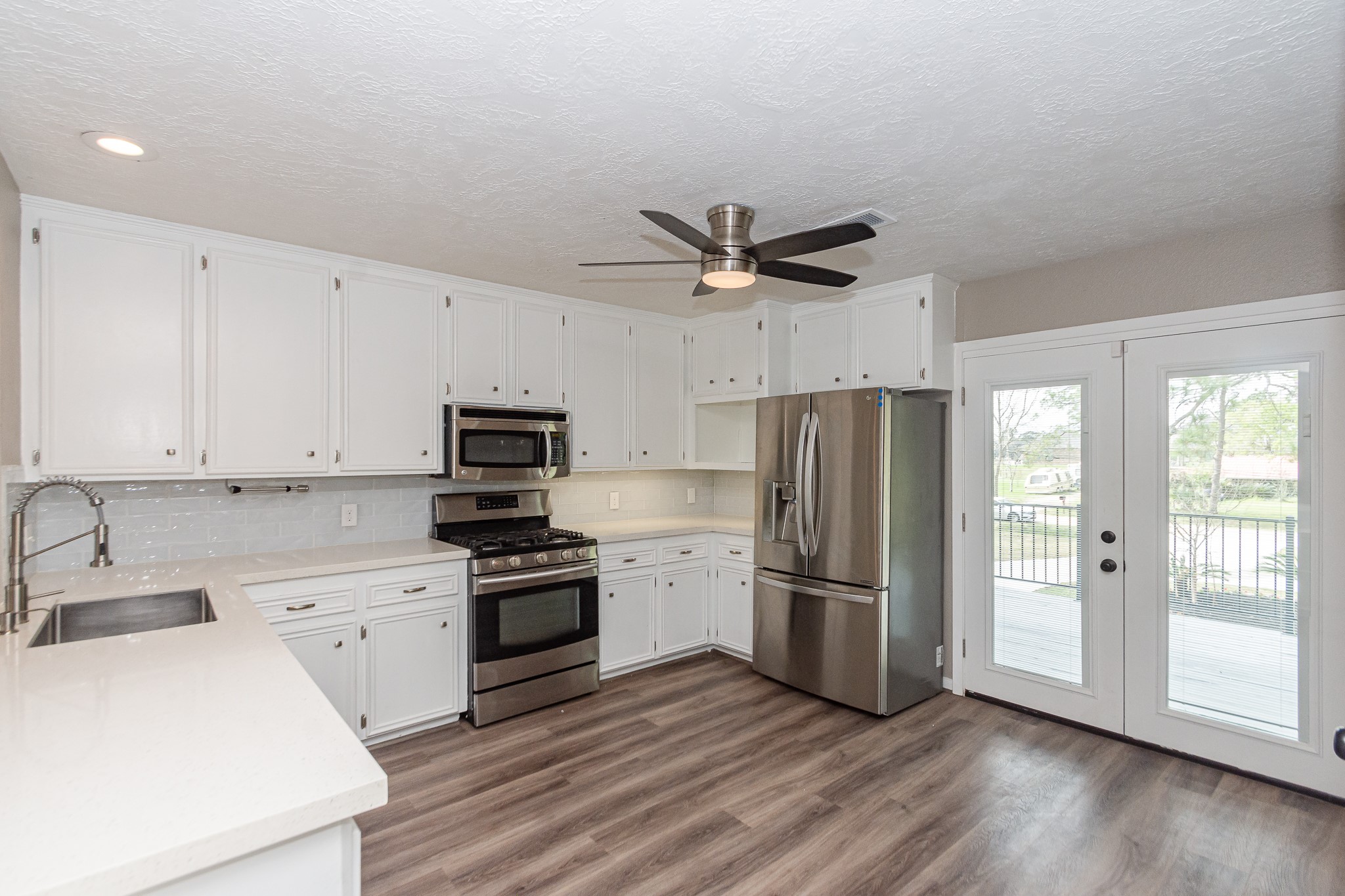 This kitchen opens beautifully to the outdoors with double French doors leading directly to the 2nd-story deck. The stainless-steel refrigerator is included.