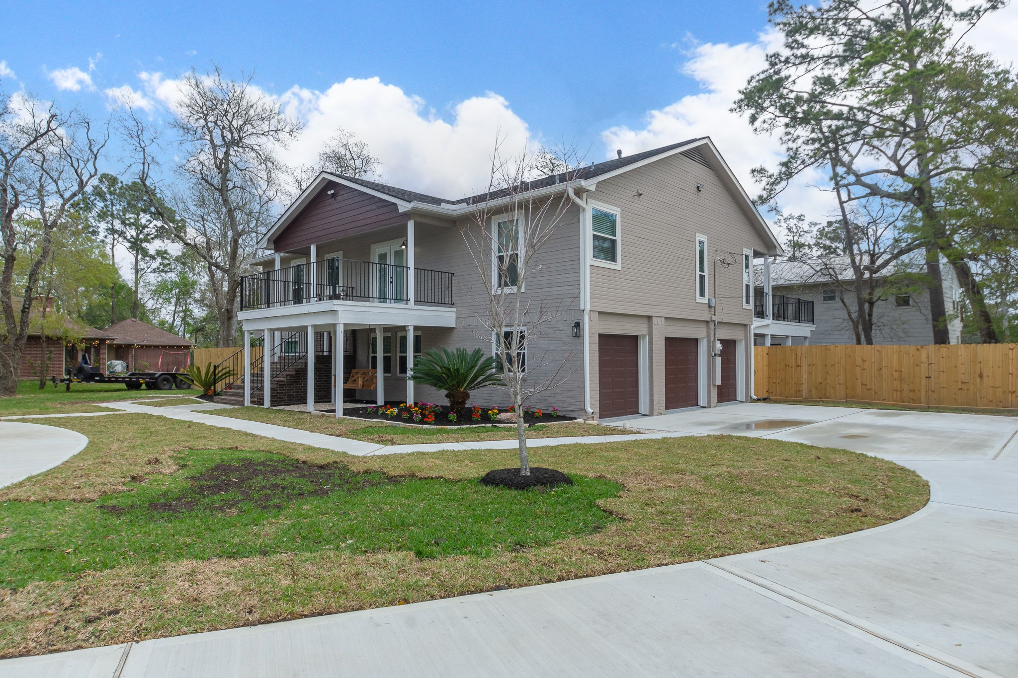 The home has a split-level front exterior. The 2nd-story deck creates a wide, shaded space beneath it.