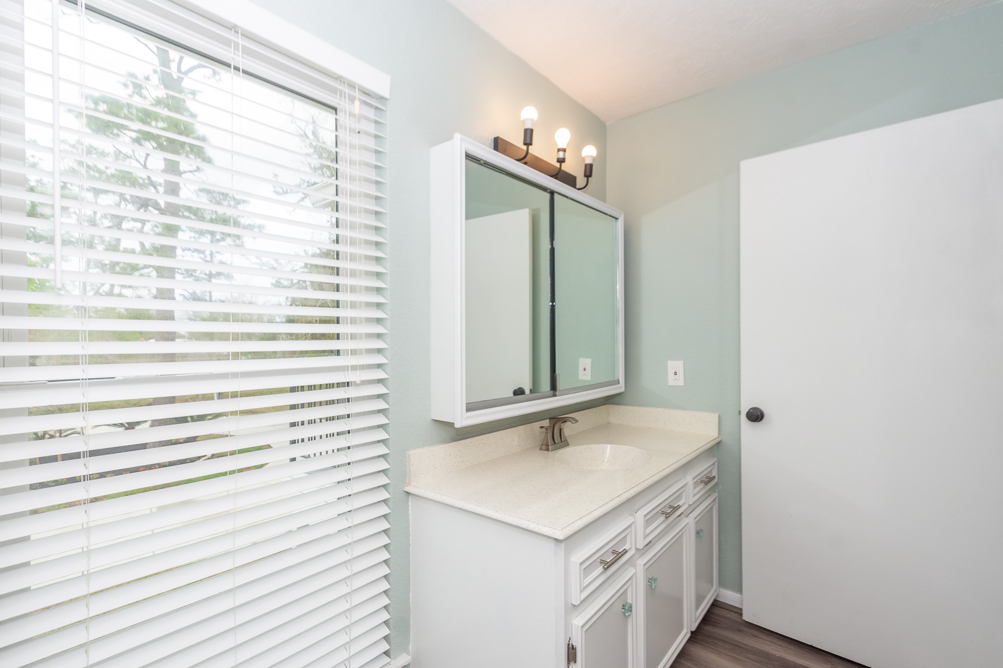 2nd view of Upstairs secondary bathroom with a full-size window overlooking the front of the home; a rare find that fills the space with natural light.