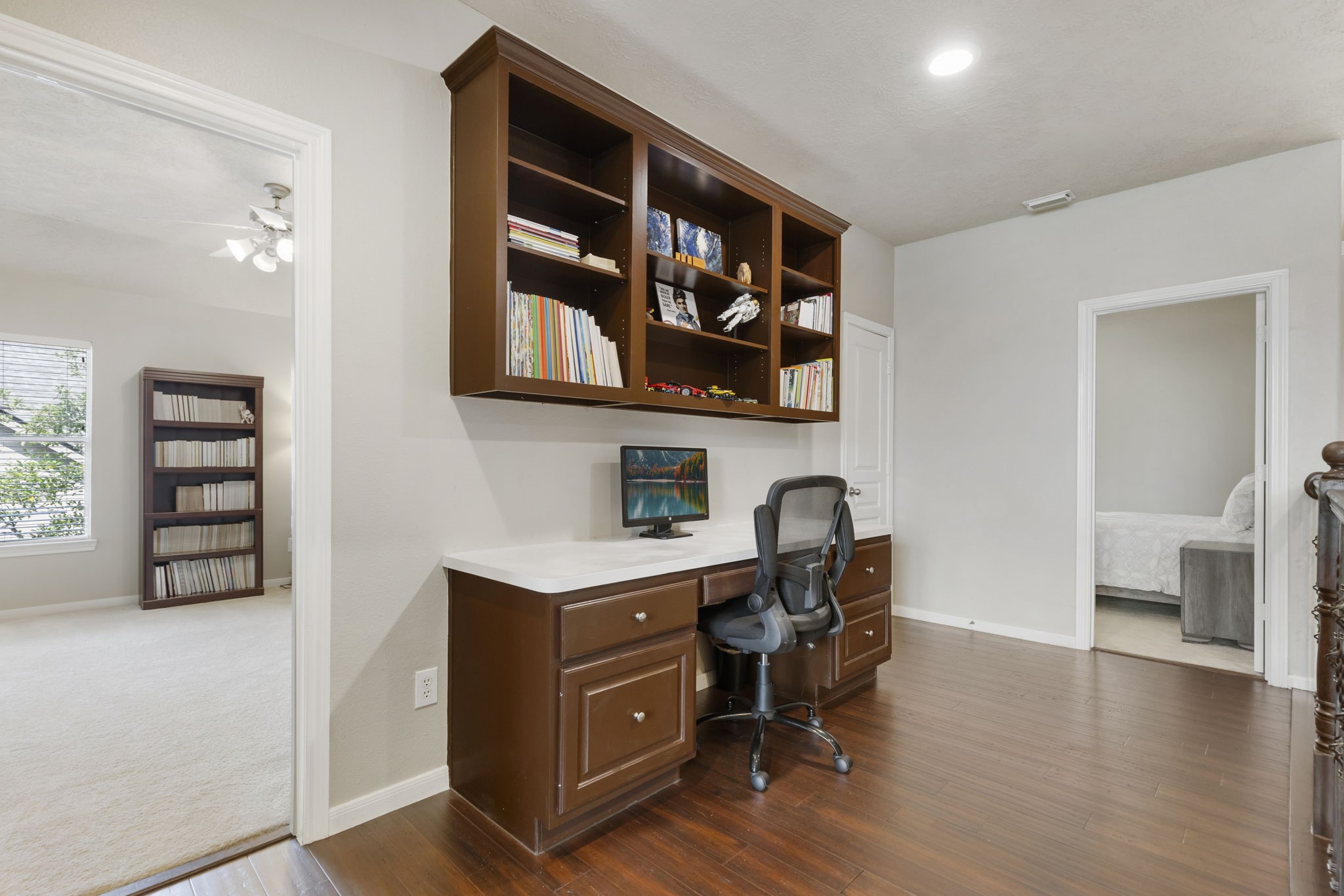 A convenient upstairs built-in desk area offers the perfect space for homework, studying, or a dedicated work-from-home setup.