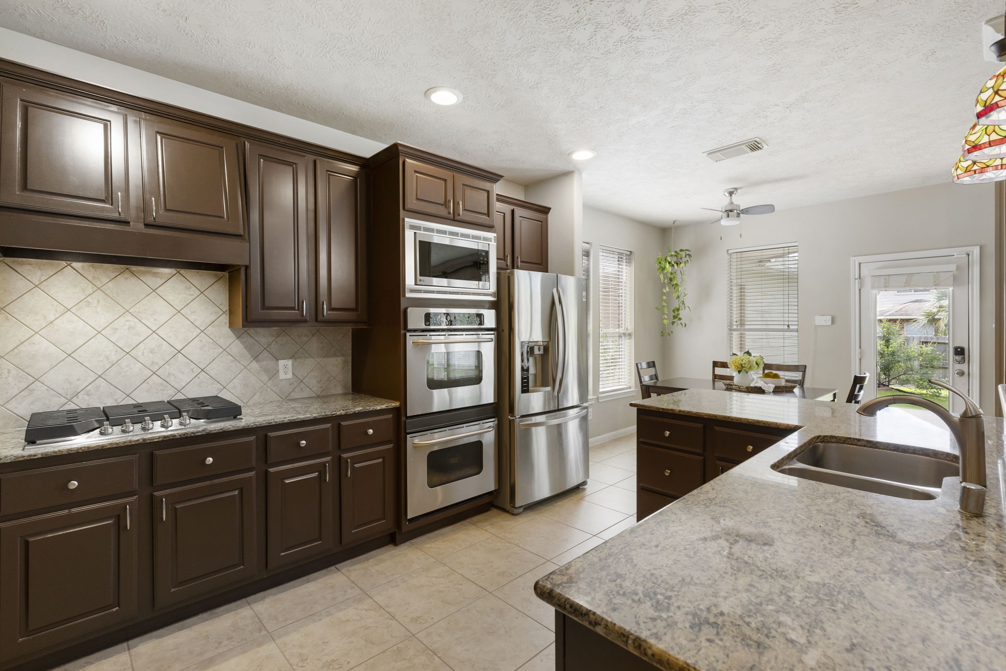 Rich cabinetry, granite countertops, and upgraded appliances come together to create a kitchen that is both stylish and practical.