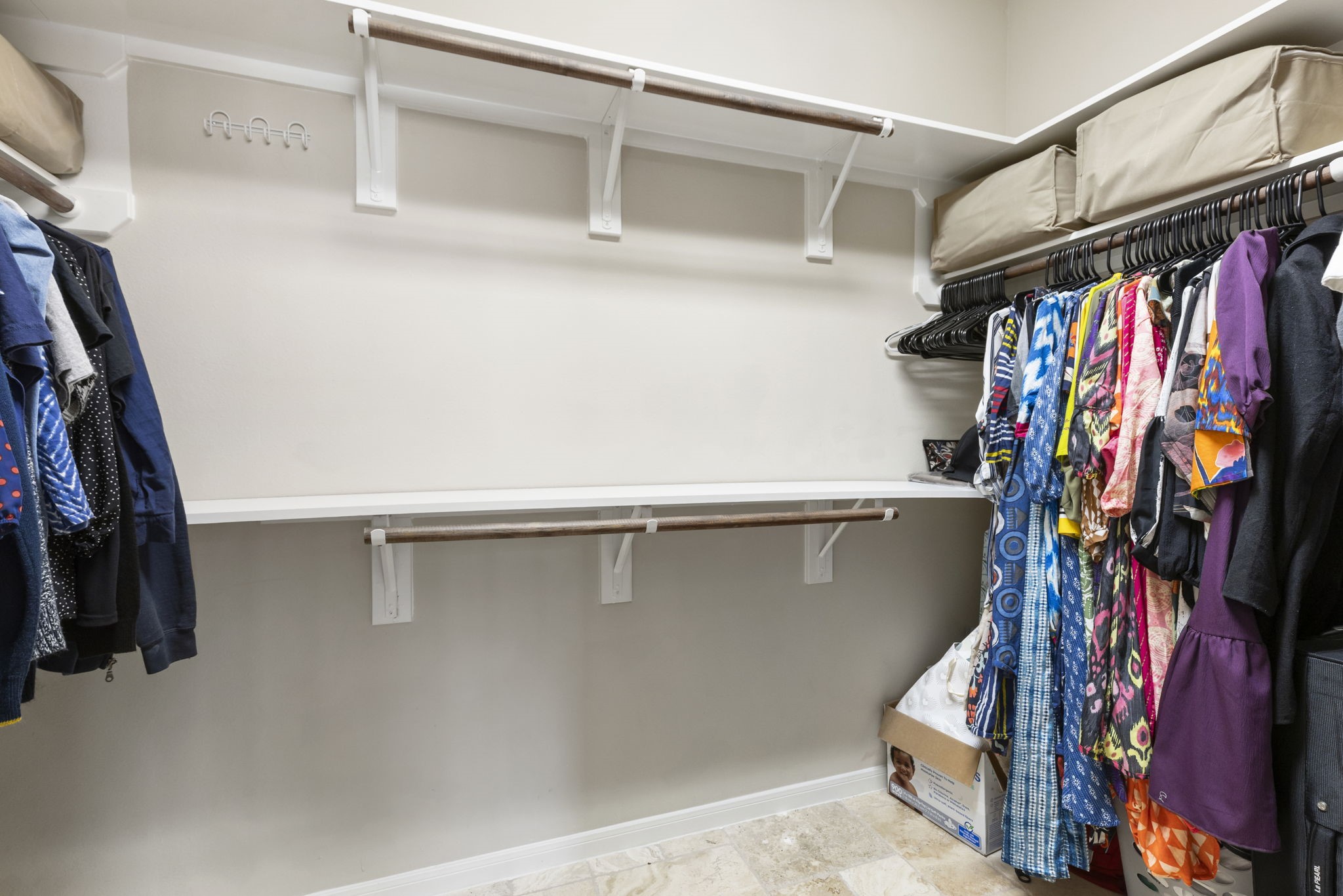 Expansive second primary closet featuring abundant hanging space and storage options.