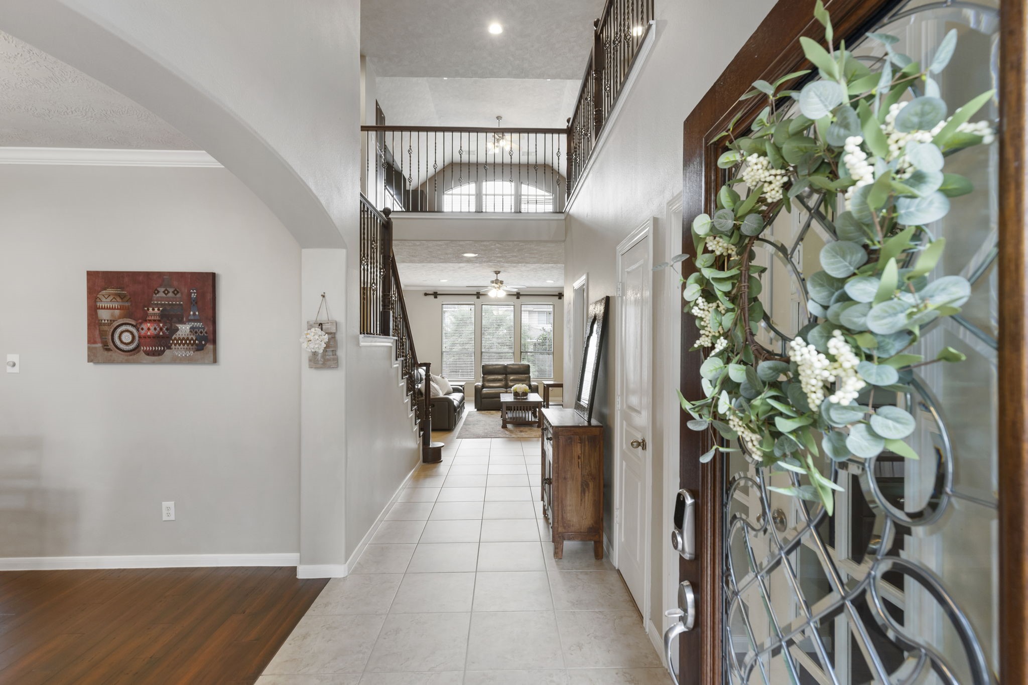 Step inside to a bright and welcoming entryway featuring soaring ceilings, beautiful tile flooring, and an open layout designed for comfortable everyday living.