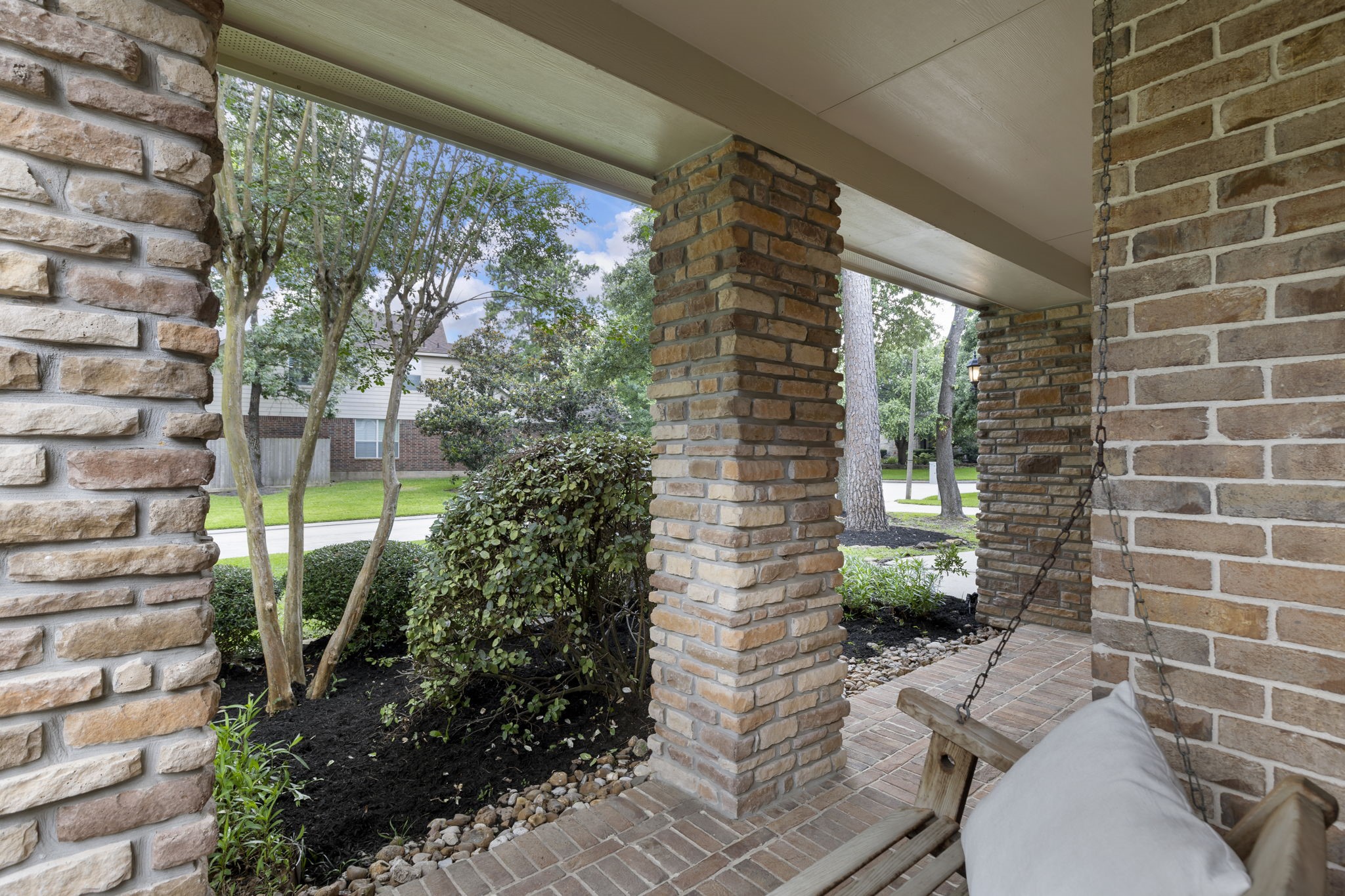 Imagine starting your mornings on this charming covered front porch swing, sipping coffee and enjoying the peaceful surroundings beneath the shade of mature trees.