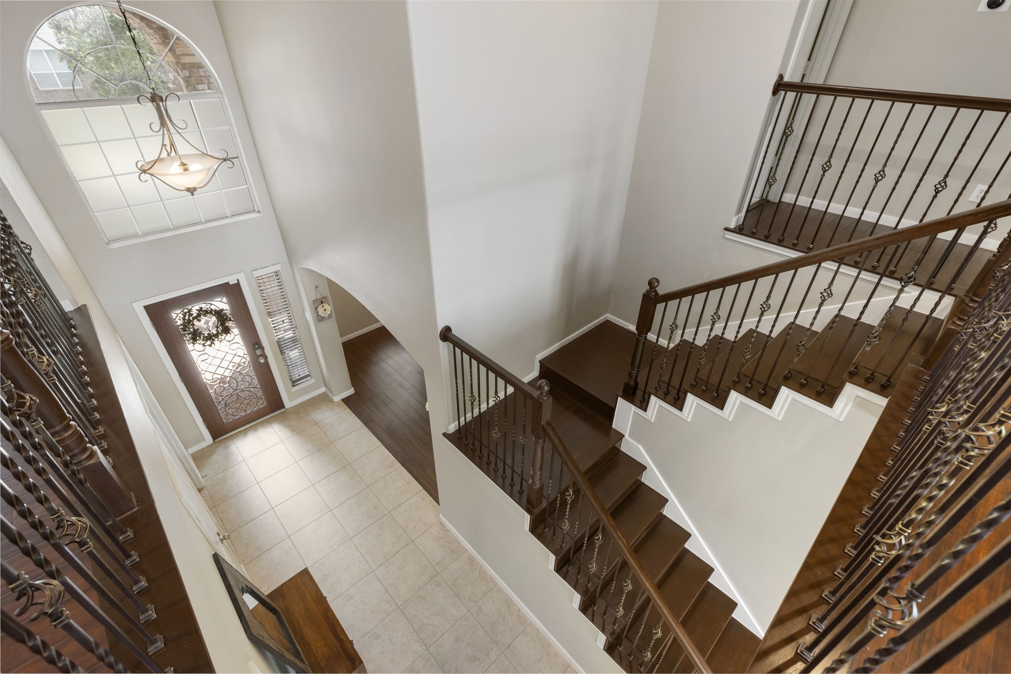 Heading upstairs, the timeless wrought iron staircase leads to four spacious secondary bedrooms and a large game room.