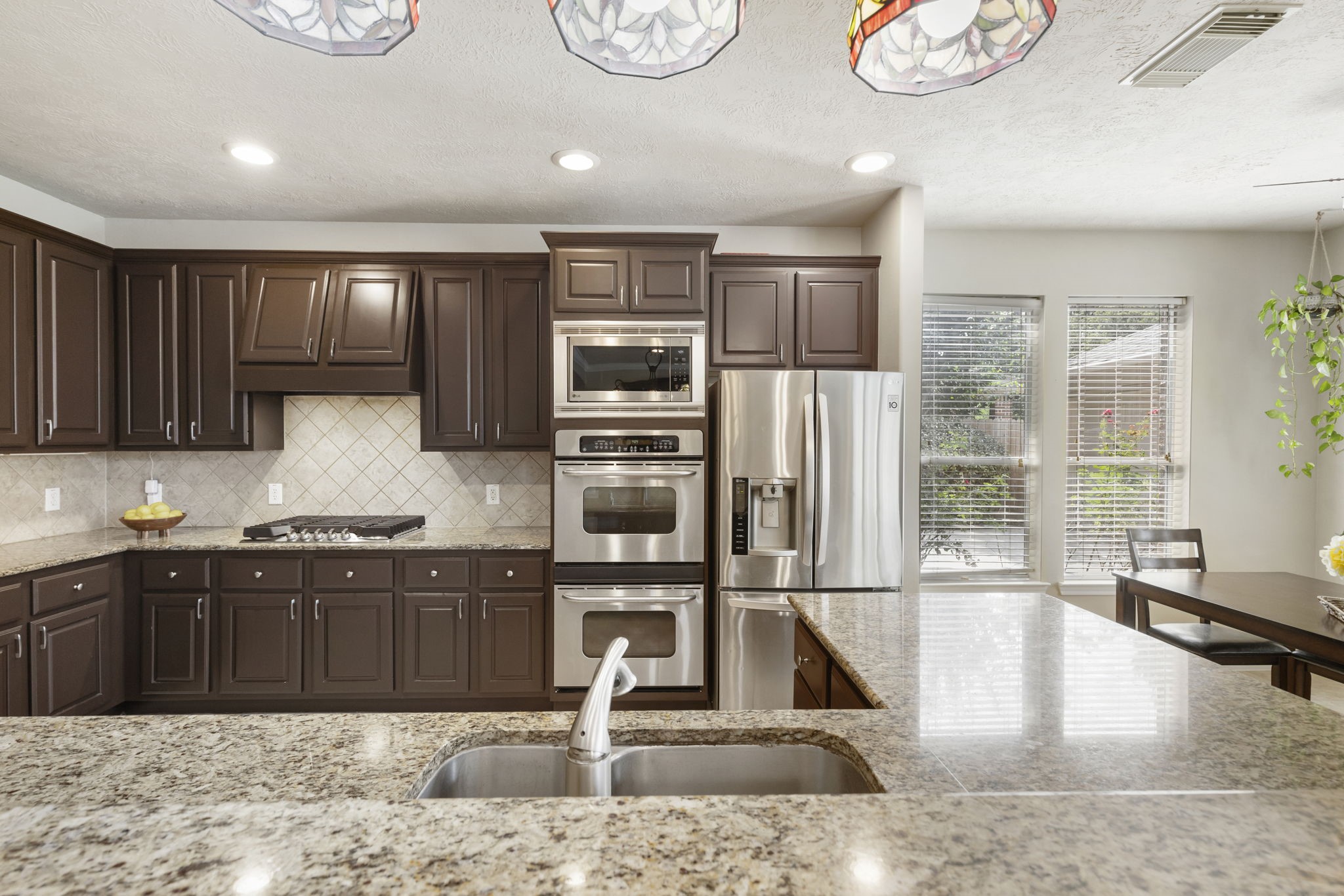 Designed with everyday living in mind, this beautiful kitchen offers generous prep space, timeless finishes, and a seamless connection to the breakfast area.