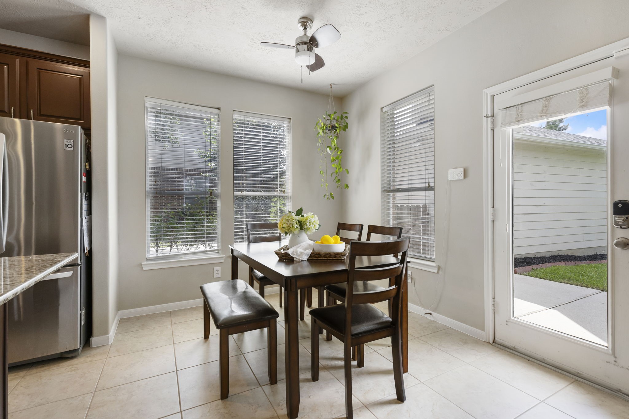 The bright breakfast area offers a comfortable space for casual meals, morning coffee, and everyday moments with views of the backyard.