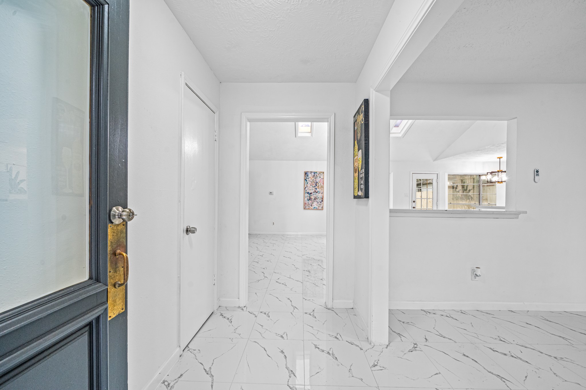 Bright and welcoming entryway featuring elegant white marble flooring, leading to spacious rooms with abundant natural light. Bright and welcoming entryway featuring elegant white marble flooring, leading to spacious rooms with abundant natural light.