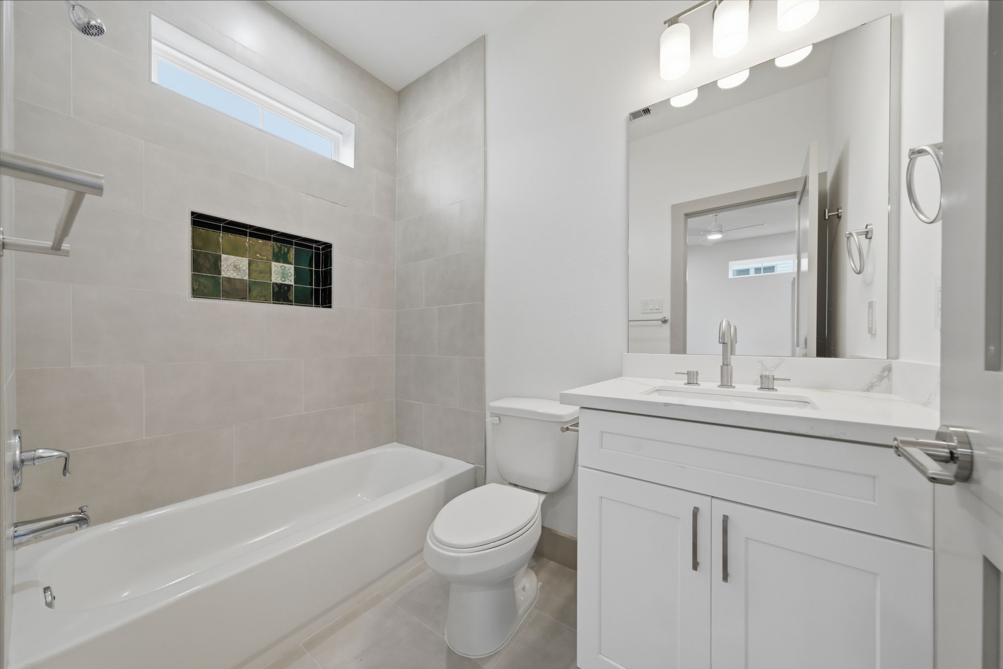 Guest bathroom on 1st floor! Note the feature tile / shampoo shelf!