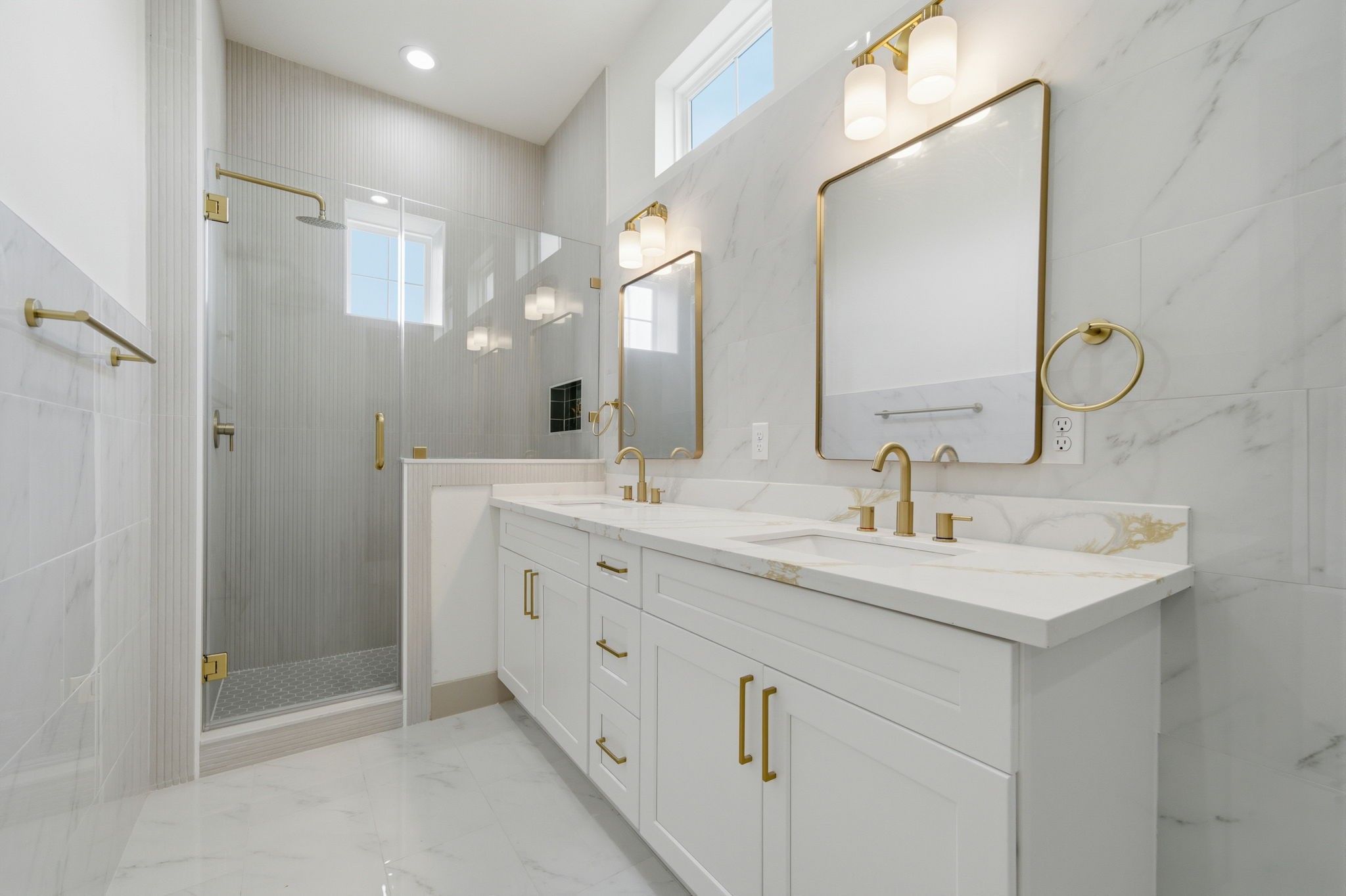 Good sized stand-up shower. Double sinks. Quartz counters continue in here. Windows up top for natural light!